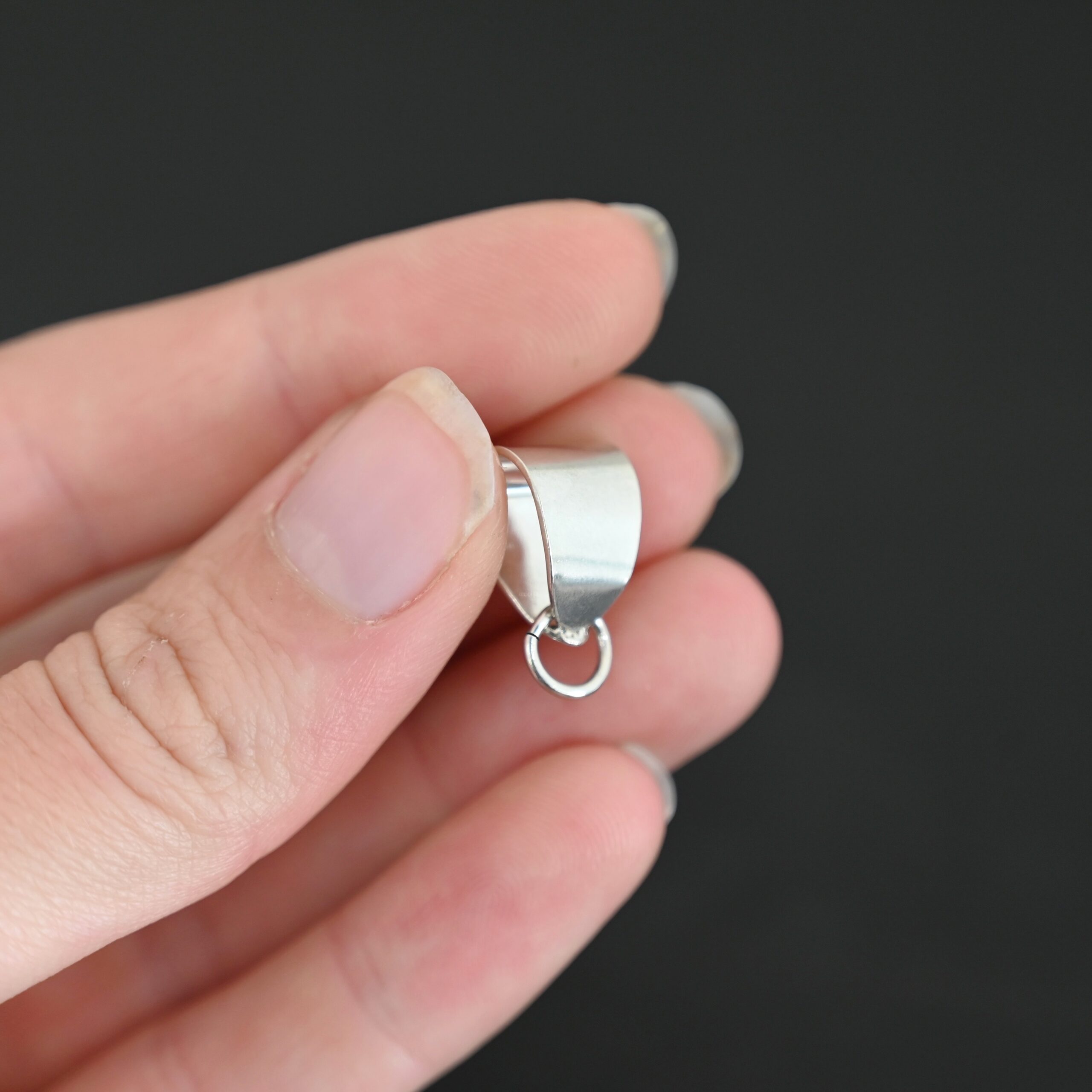 Handmade Pinch Bail - shiny open jump ring shown in hand