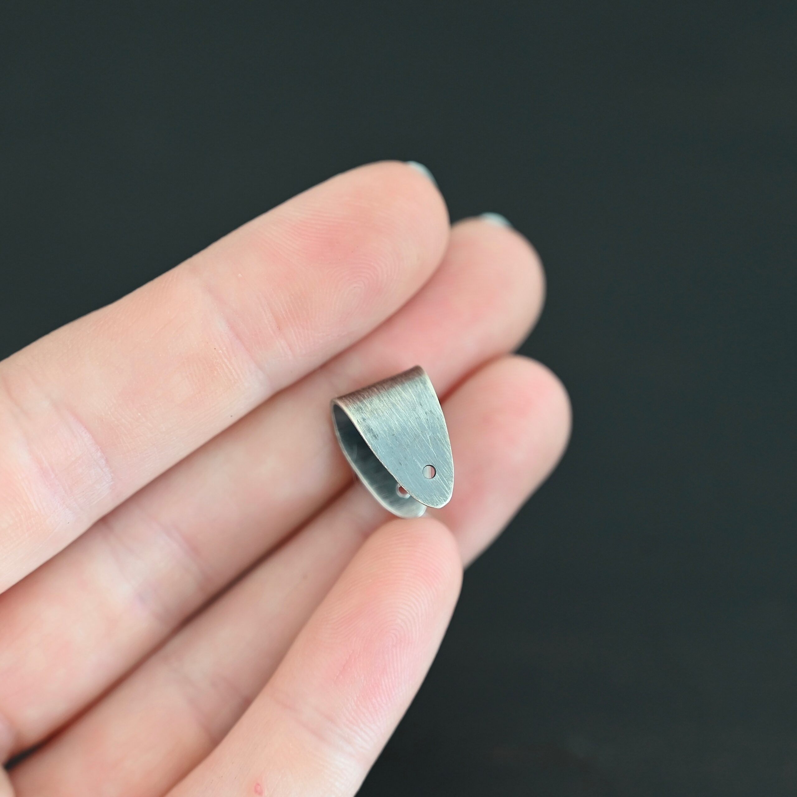 Handmade Pinch Bail - oxidized plain shown in hand