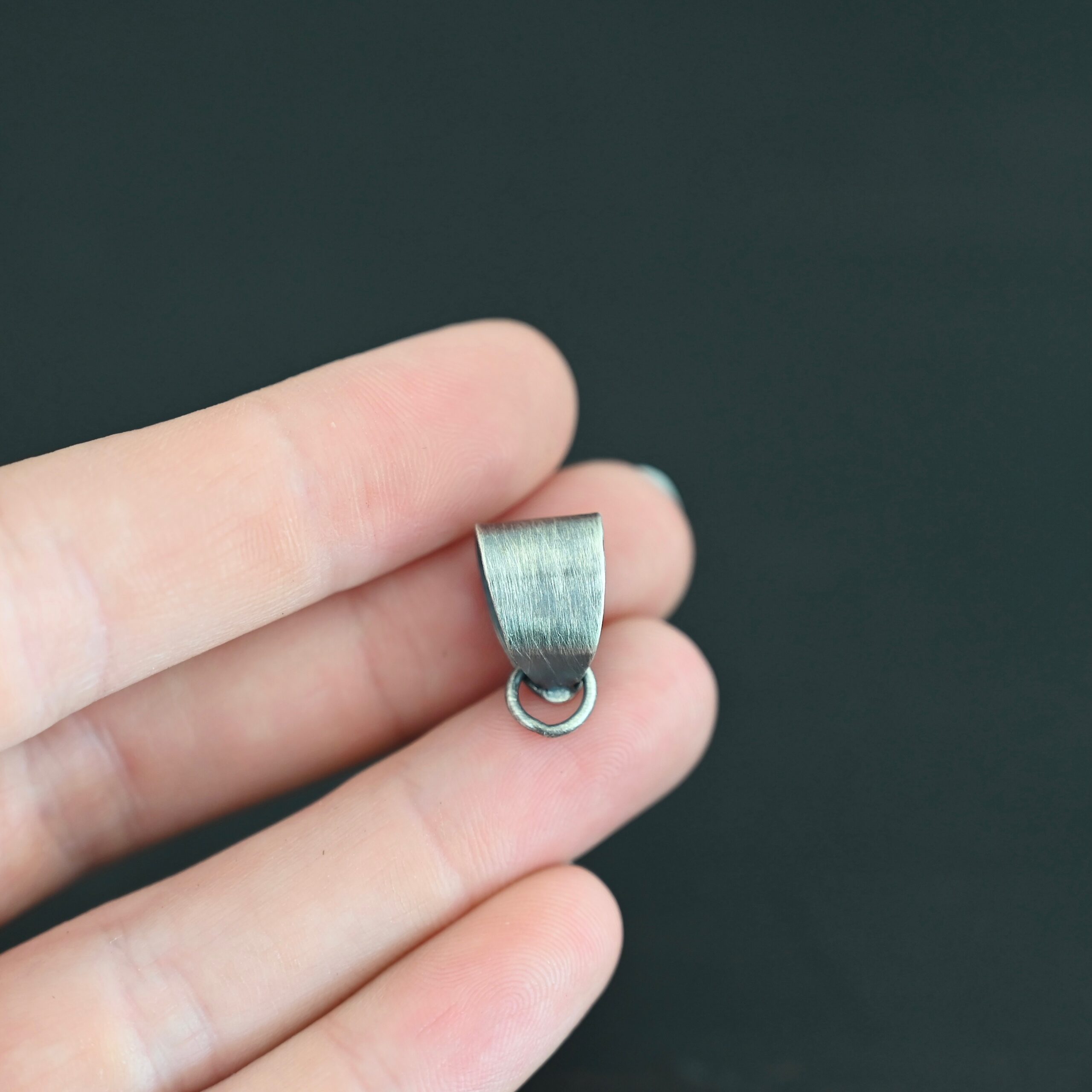 Handmade Pinch Bail - oxidized soldered jump ring shown in hand