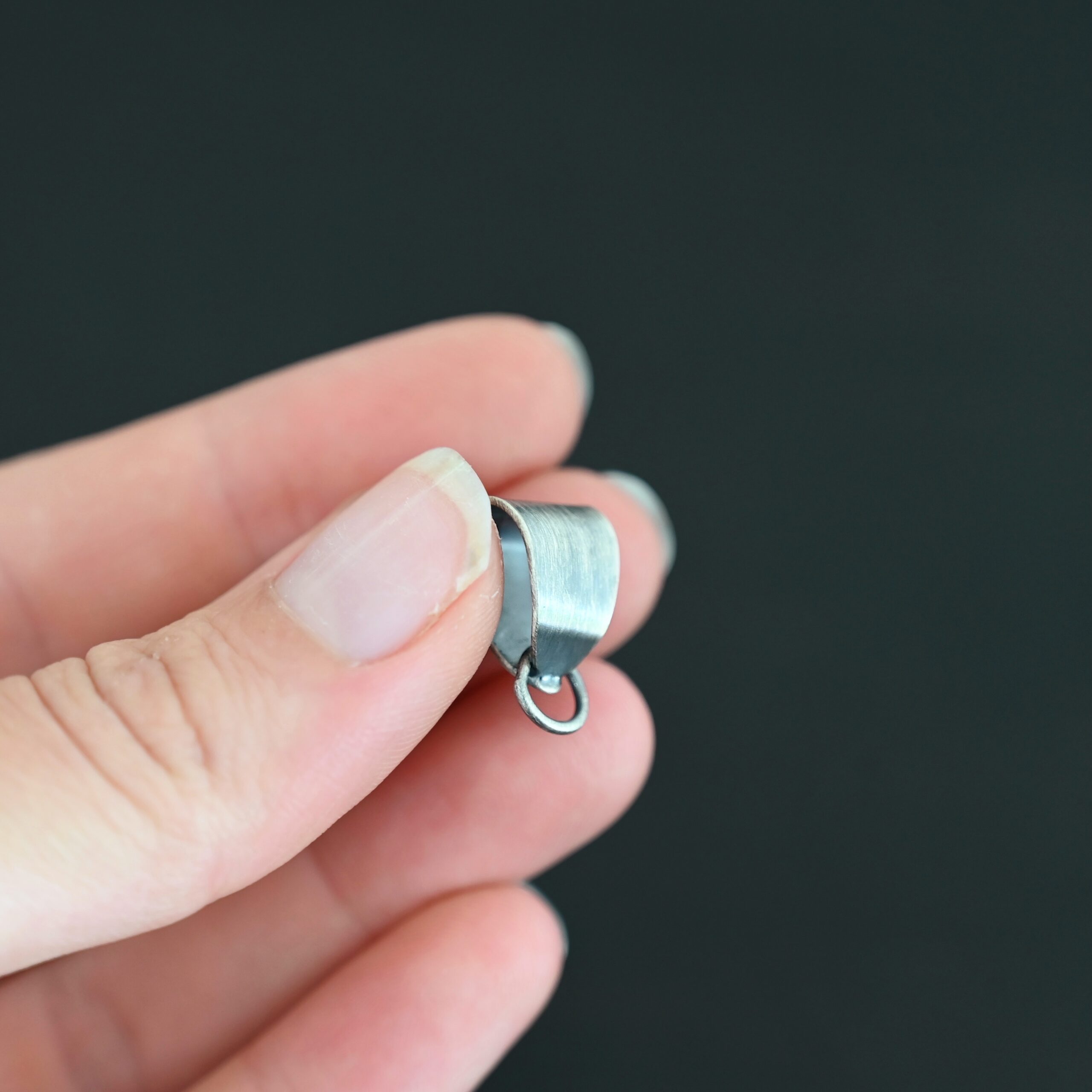 Handmade Pinch Bail - oxidized soldered jump ring shown in hand