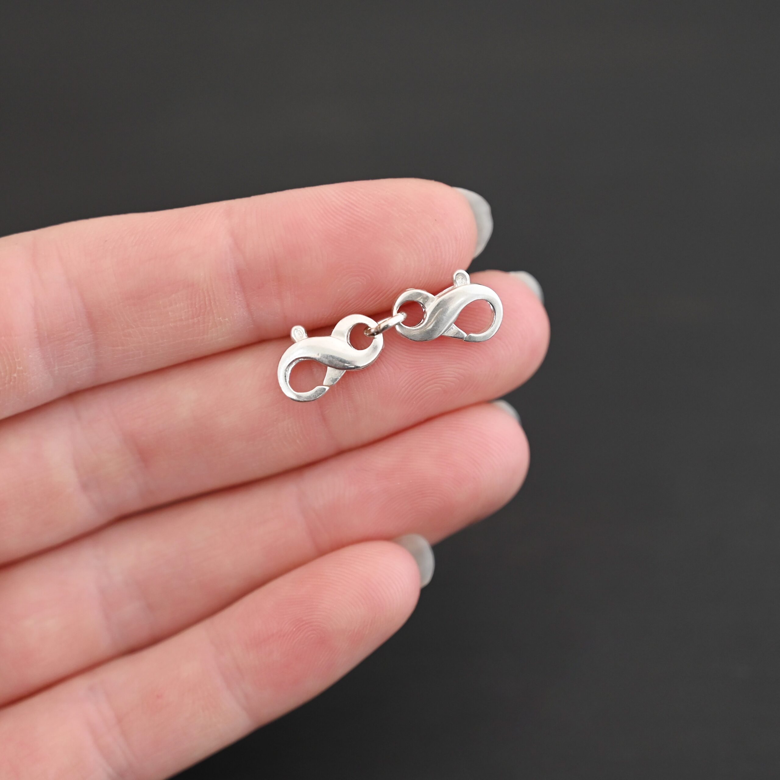 Faith double figure 8 clasp - shiny shown in hand