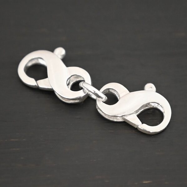 Faith double figure 8 clasp - shiny shown on dark background