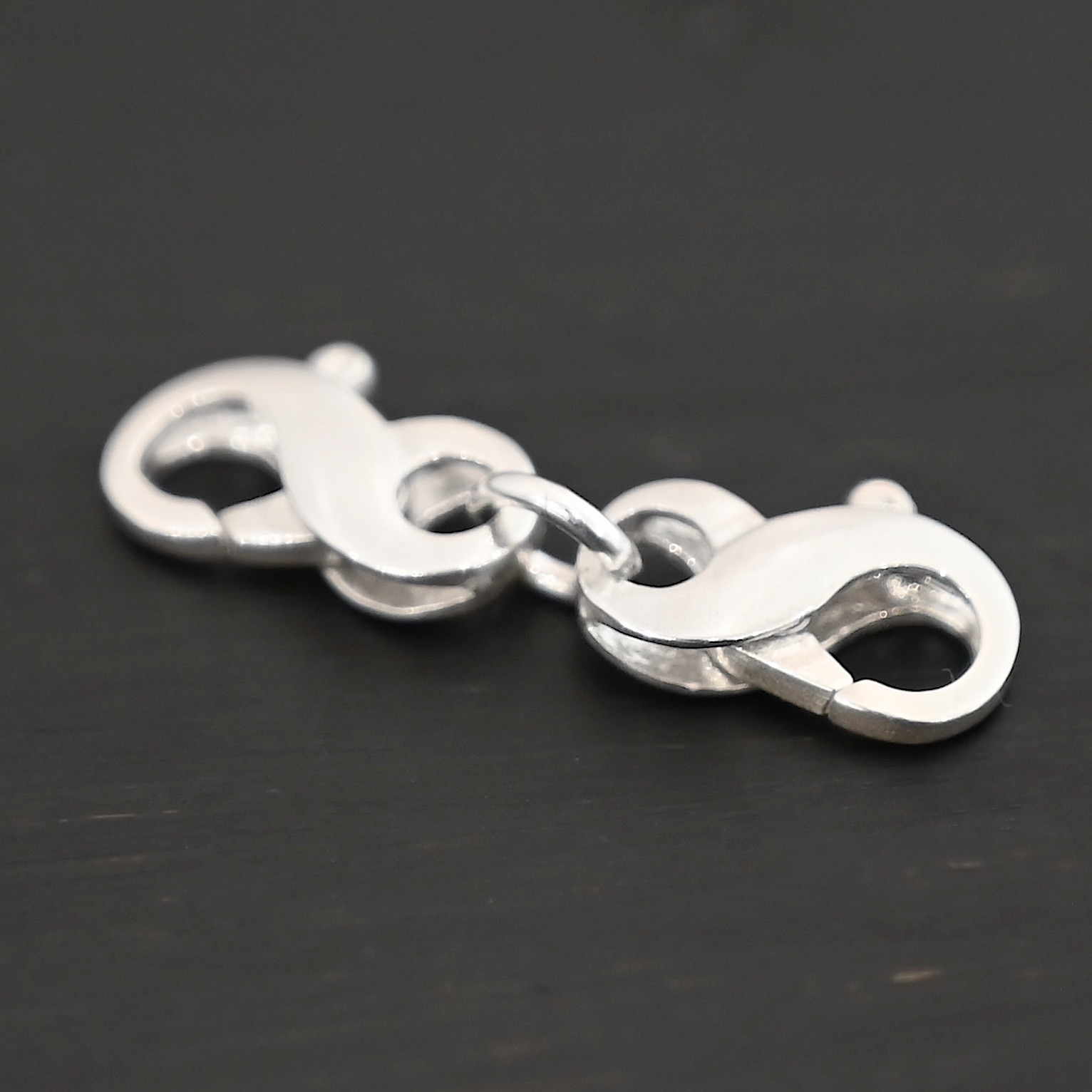 Faith double figure 8 clasp - shiny shown on dark background