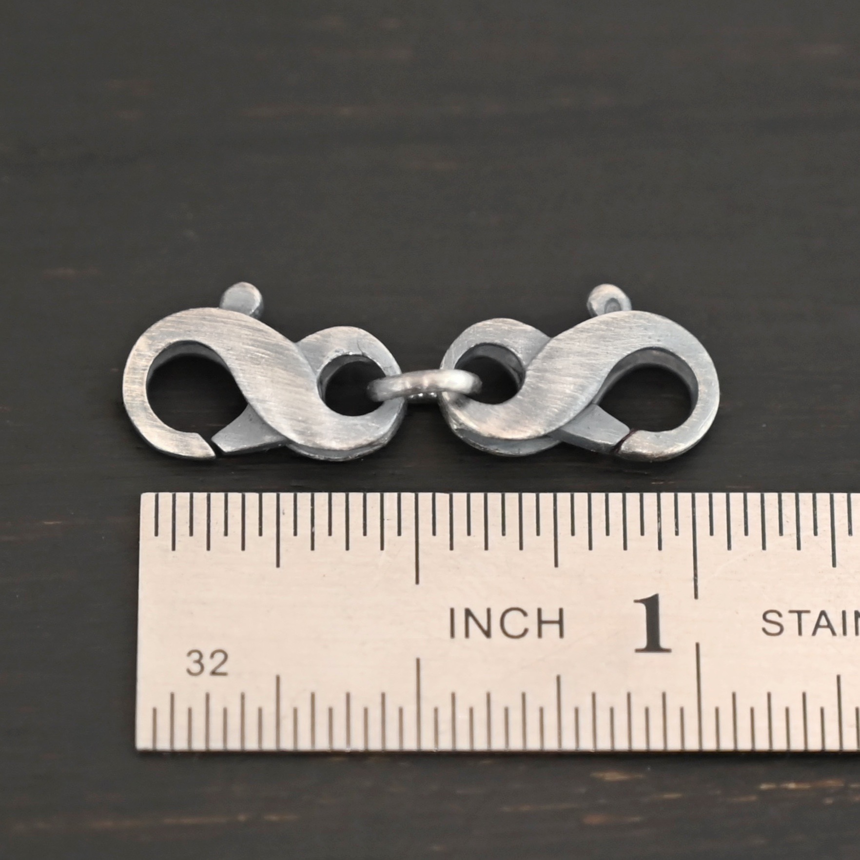 Faith double figure 8 clasp - oxidized shown by ruler