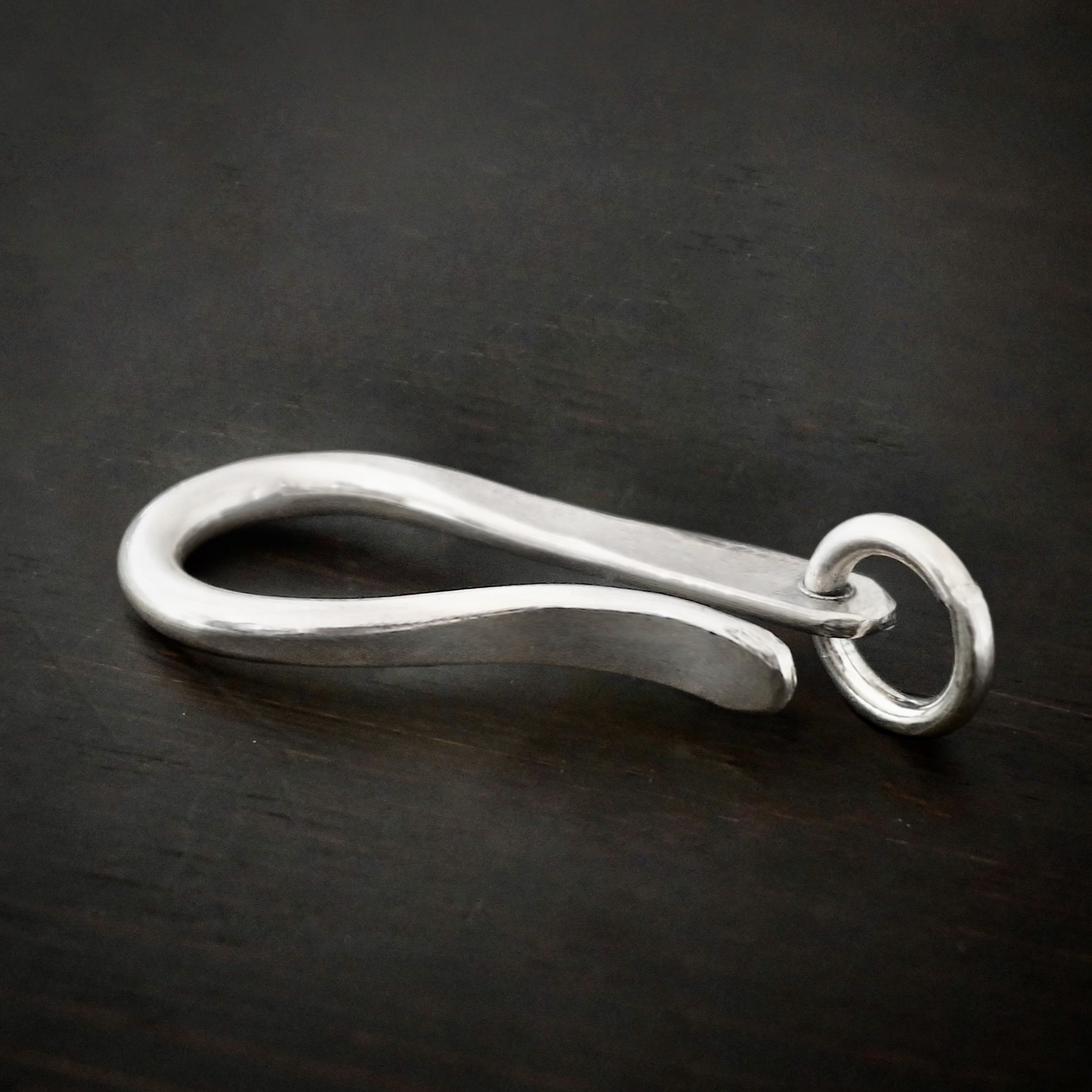 Harrison Hook Clasp - shiny Harrison Hook Clasp - shiny shown on dark background