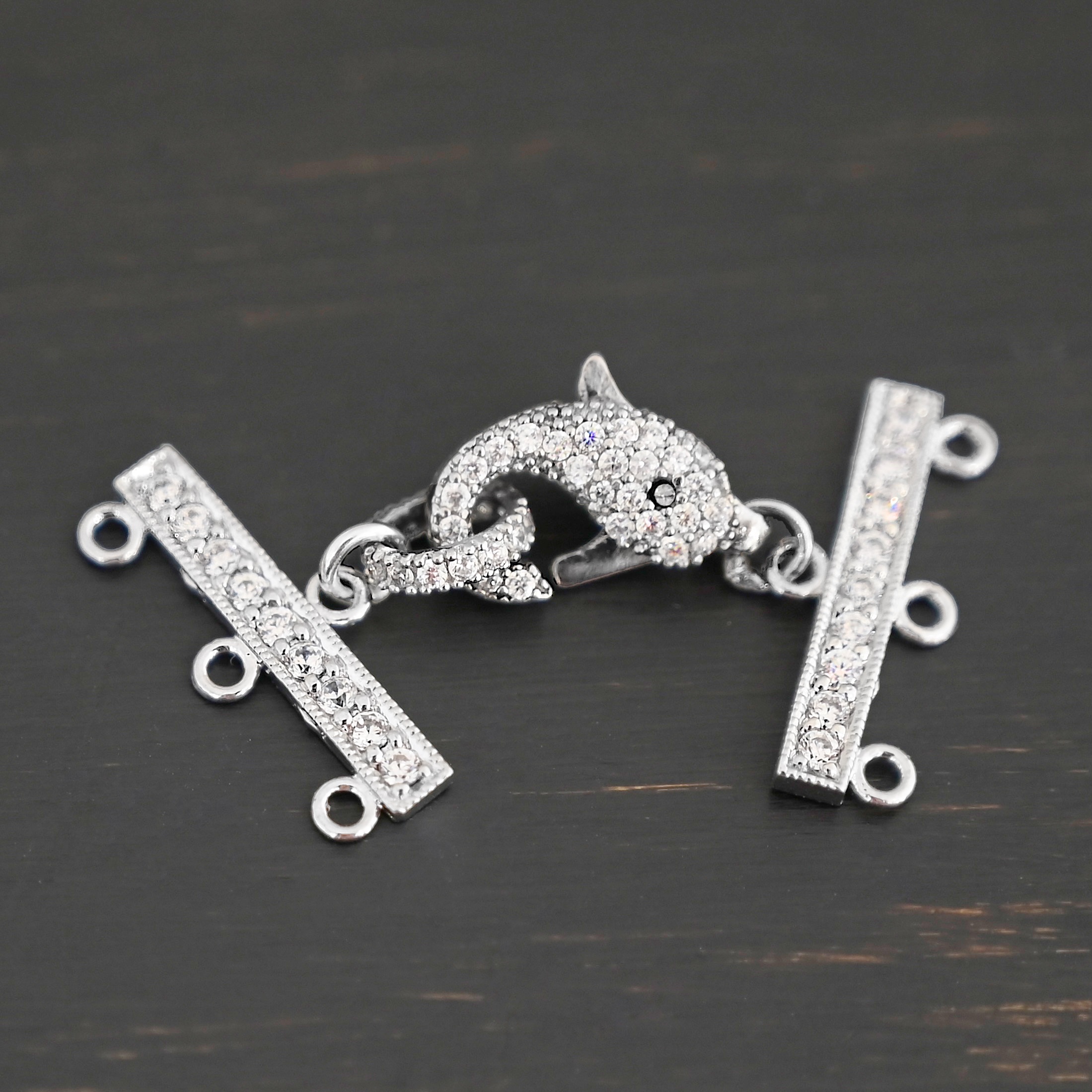 Molly CZ 3 strand clasp shown on dark background