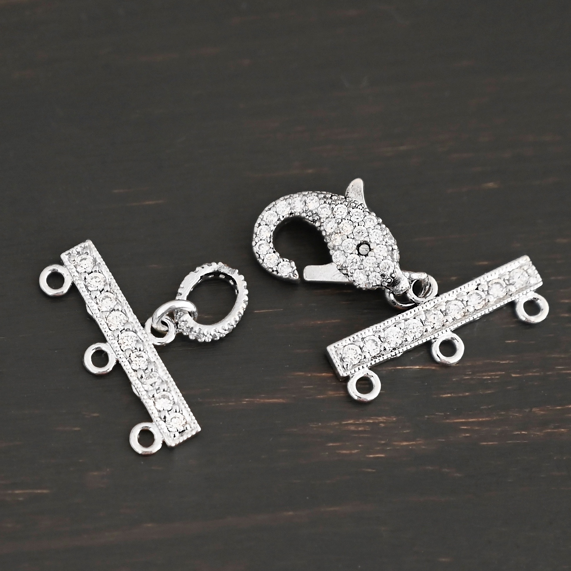 Molly CZ 3 strand clasp shown on dark background