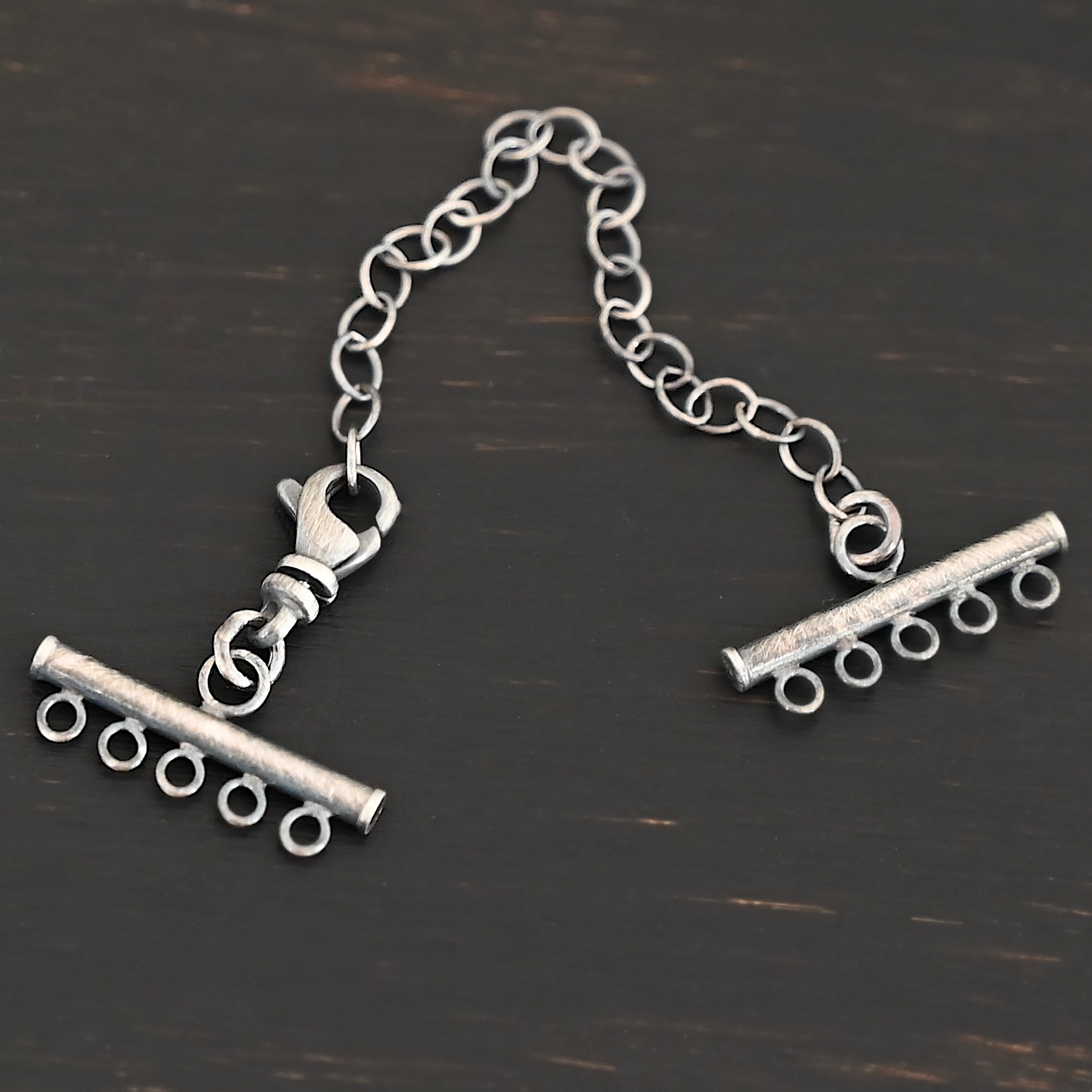 Matthew multistrand clasp - oxidized 5 strand Matthew multistrand clasp - oxidized 5 strand shown on dark background