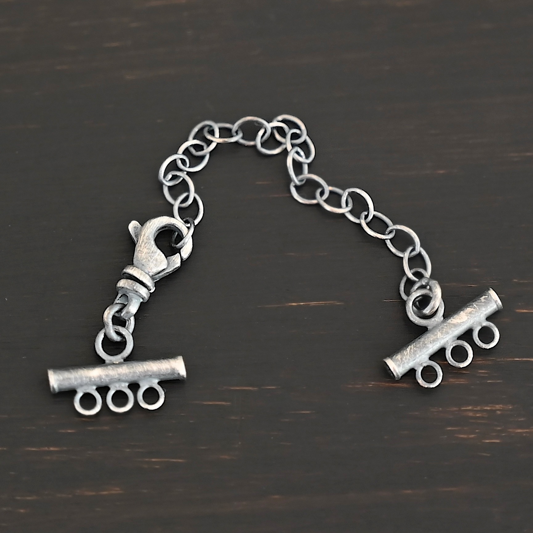 Matthew multistrand clasp - oxidized 3 strand Matthew multistrand clasp - oxidized 3 strand shown on dark background