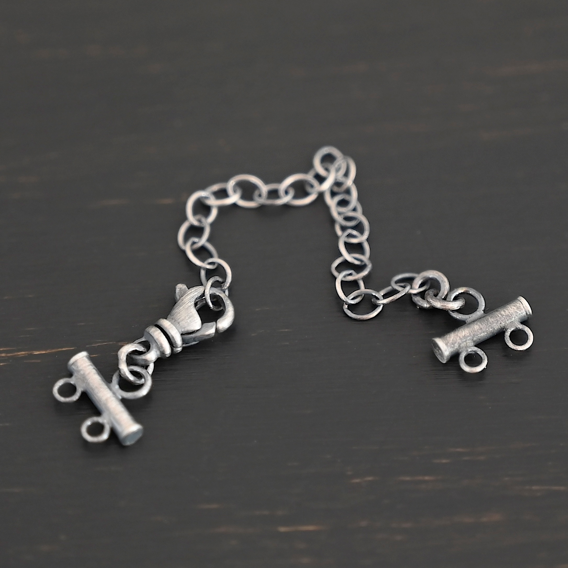 Matthew multistrand clasp - oxidized 2 strand Matthew multistrand clasp - oxidized 2 strand shown on dark background