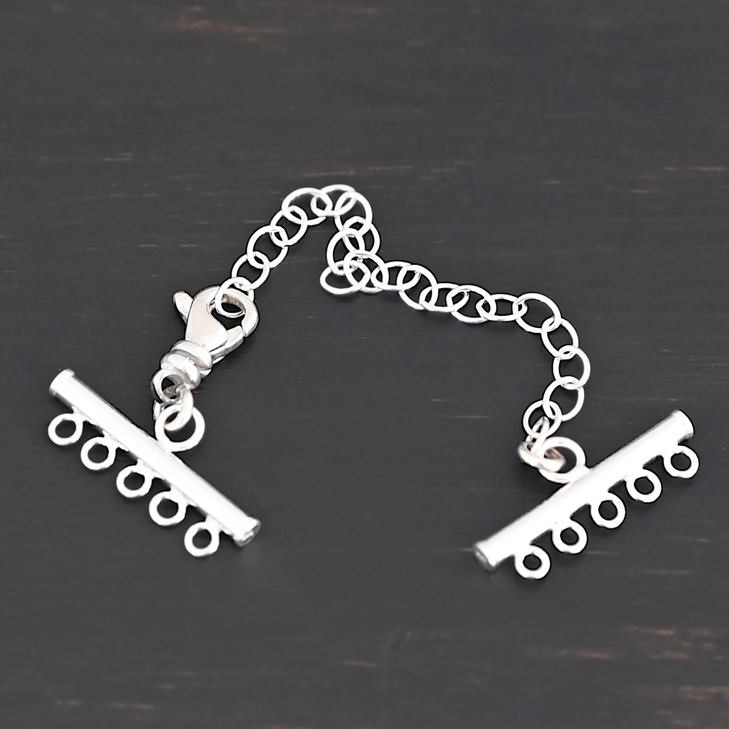 Matthew multistrand clasp - shiny 5 strand Matthew multistrand clasp - shiny 5 strand shown on dark background