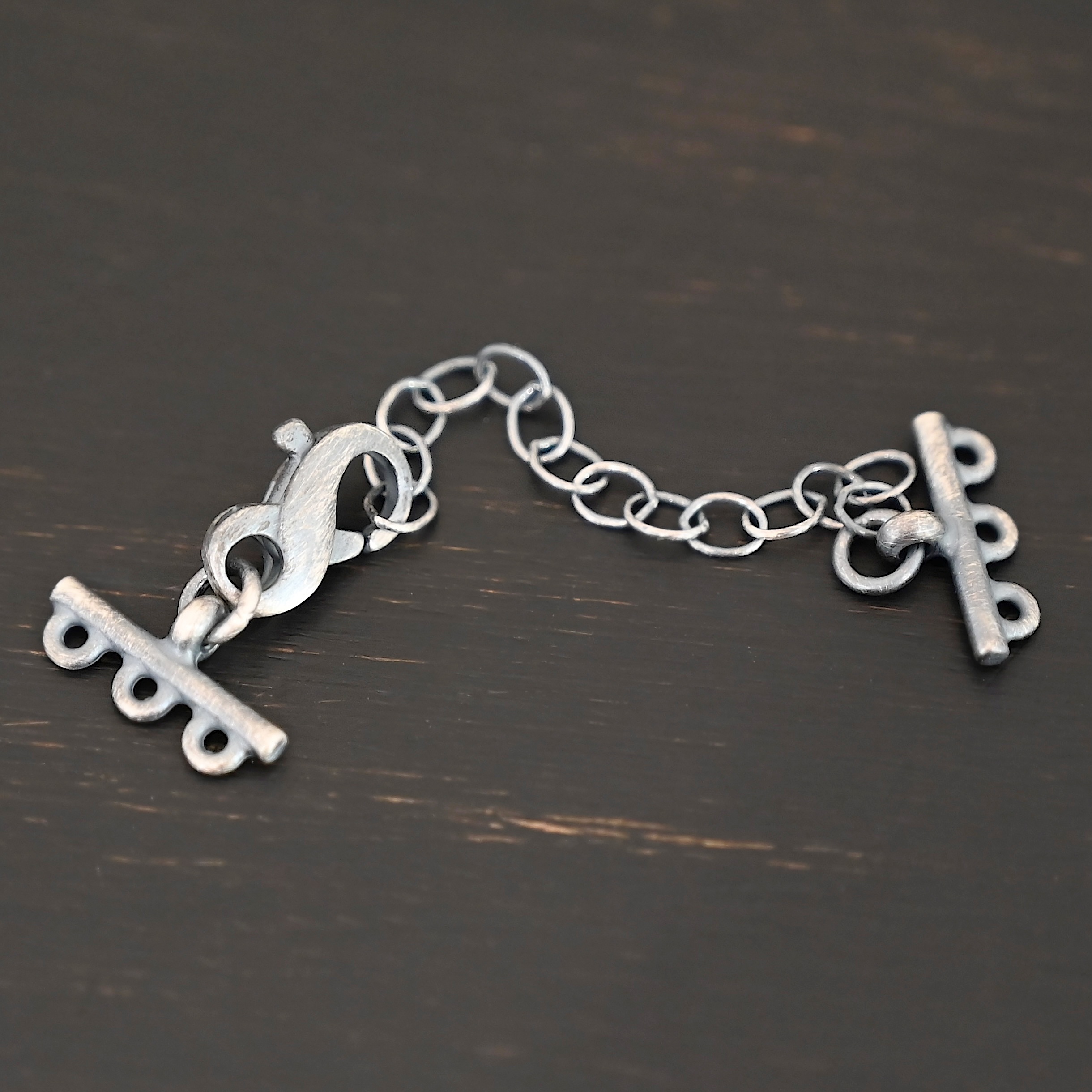 Max multistrand clasp - oxidized 3 strand shown on dark background