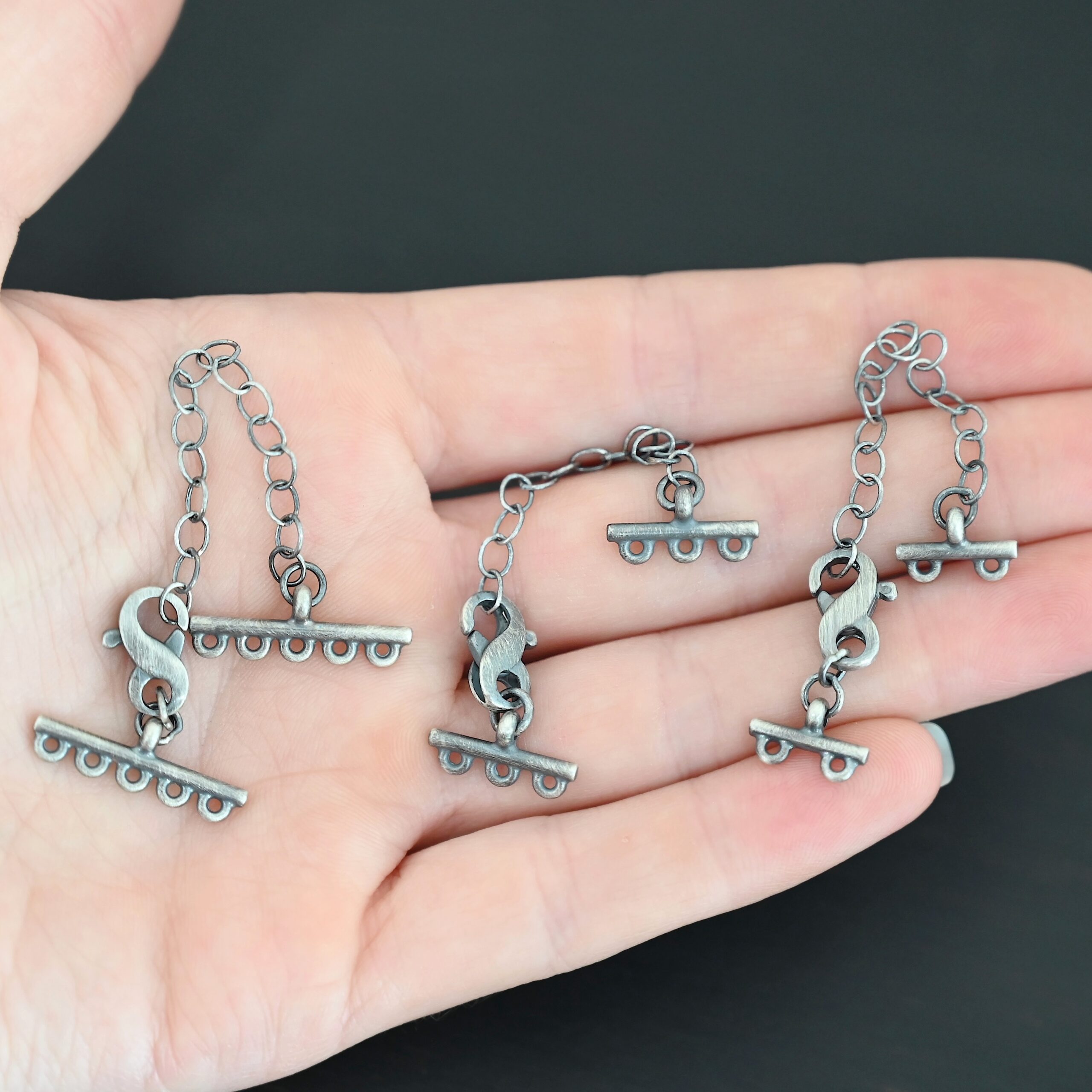 Max multistrand clasp - oxidized shown in hand