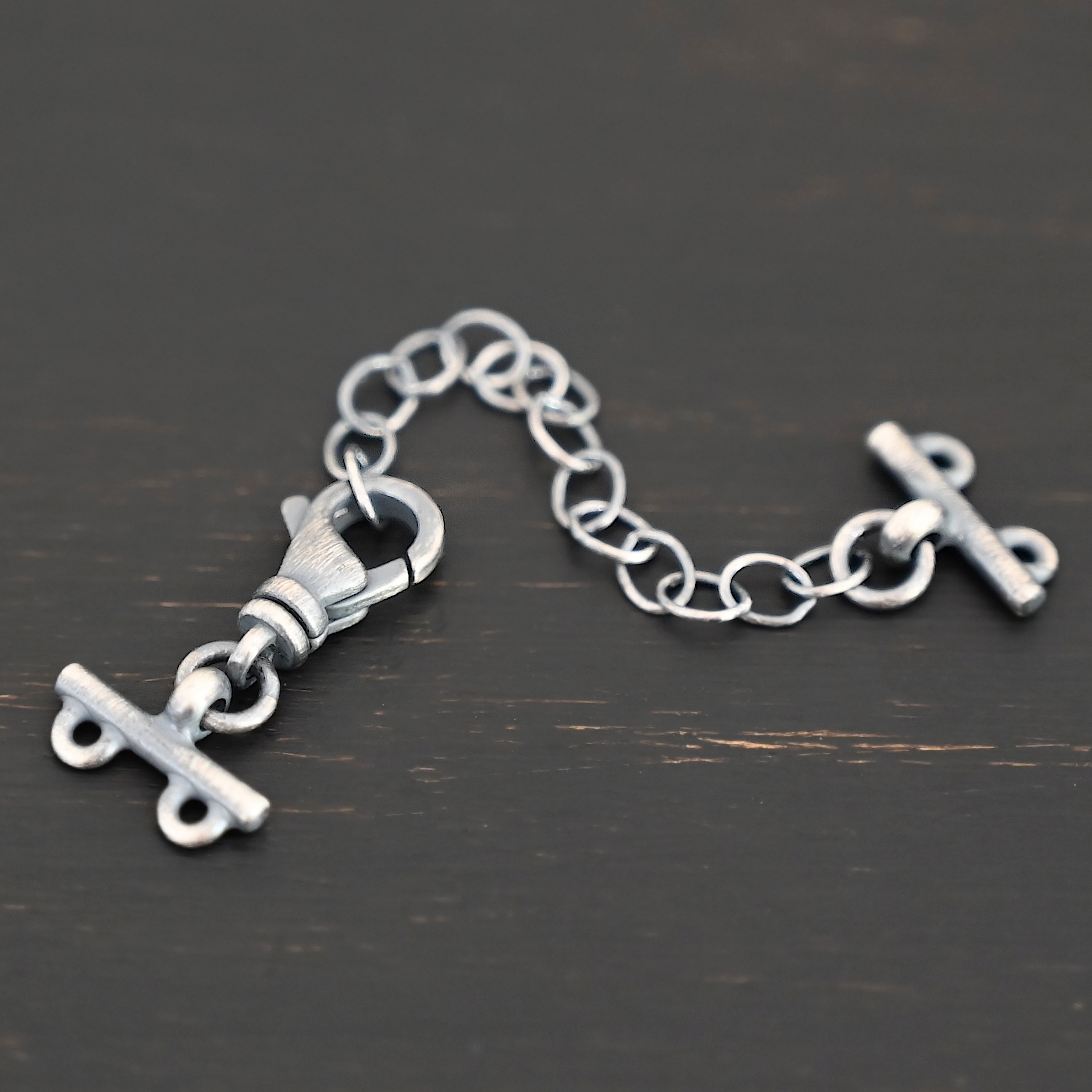 Myles multistrand clasp - oxidized 2 strand Myles multistrand clasp - oxidized 2 strand shown on dark background