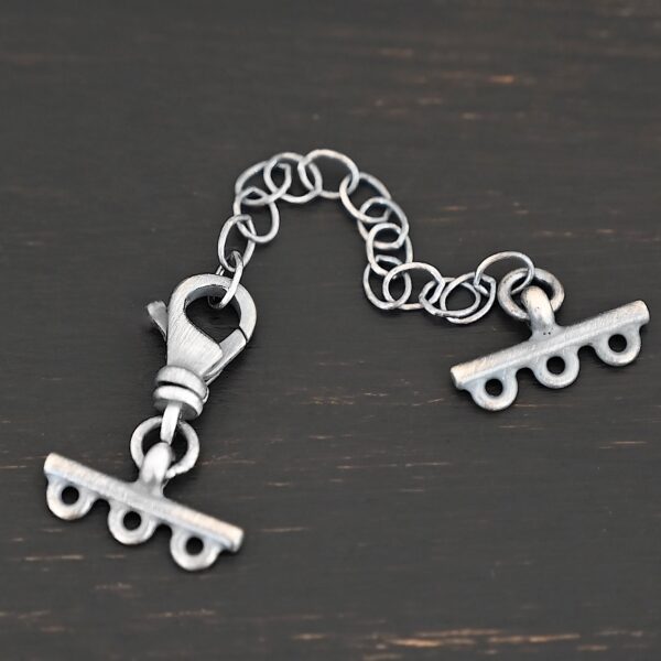 Myles multistrand clasp - oxidized 3 strand shown on dark background