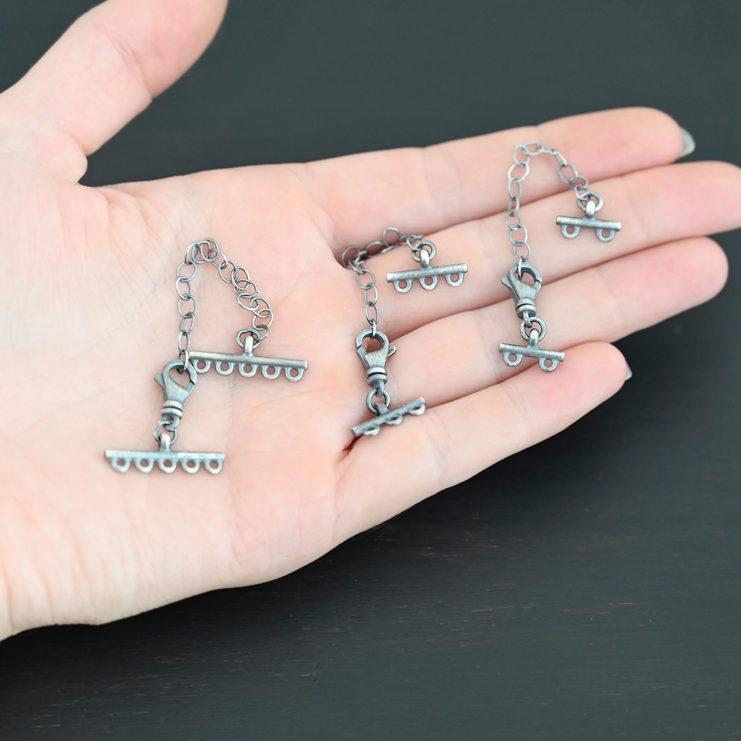 Myles multistrand clasp - oxidized Myles multistrand clasp - oxidized shown in hand