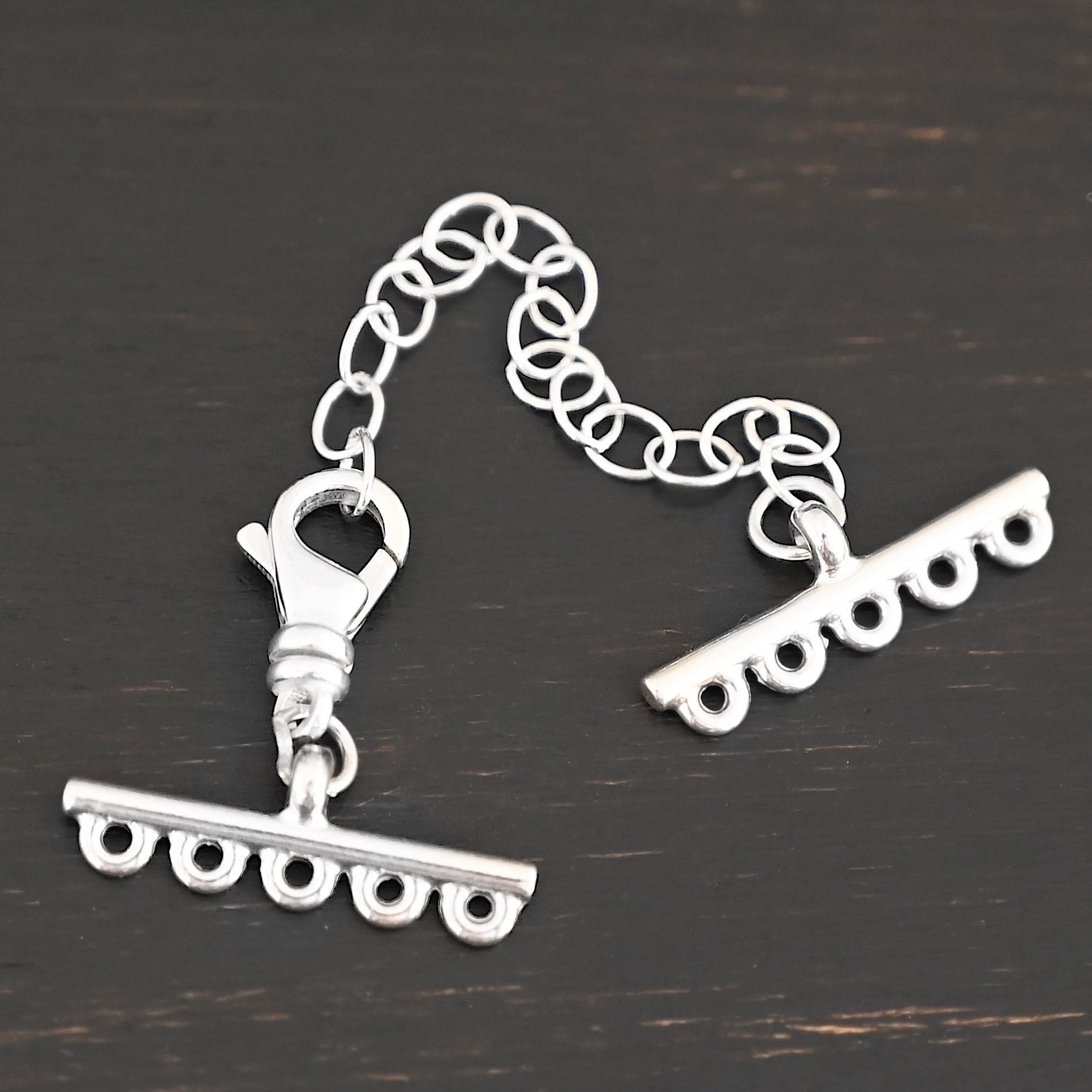 Myles multistrand clasp - shiny 5 strand Myles multistrand clasp - shiny 5 strand shown on dark background