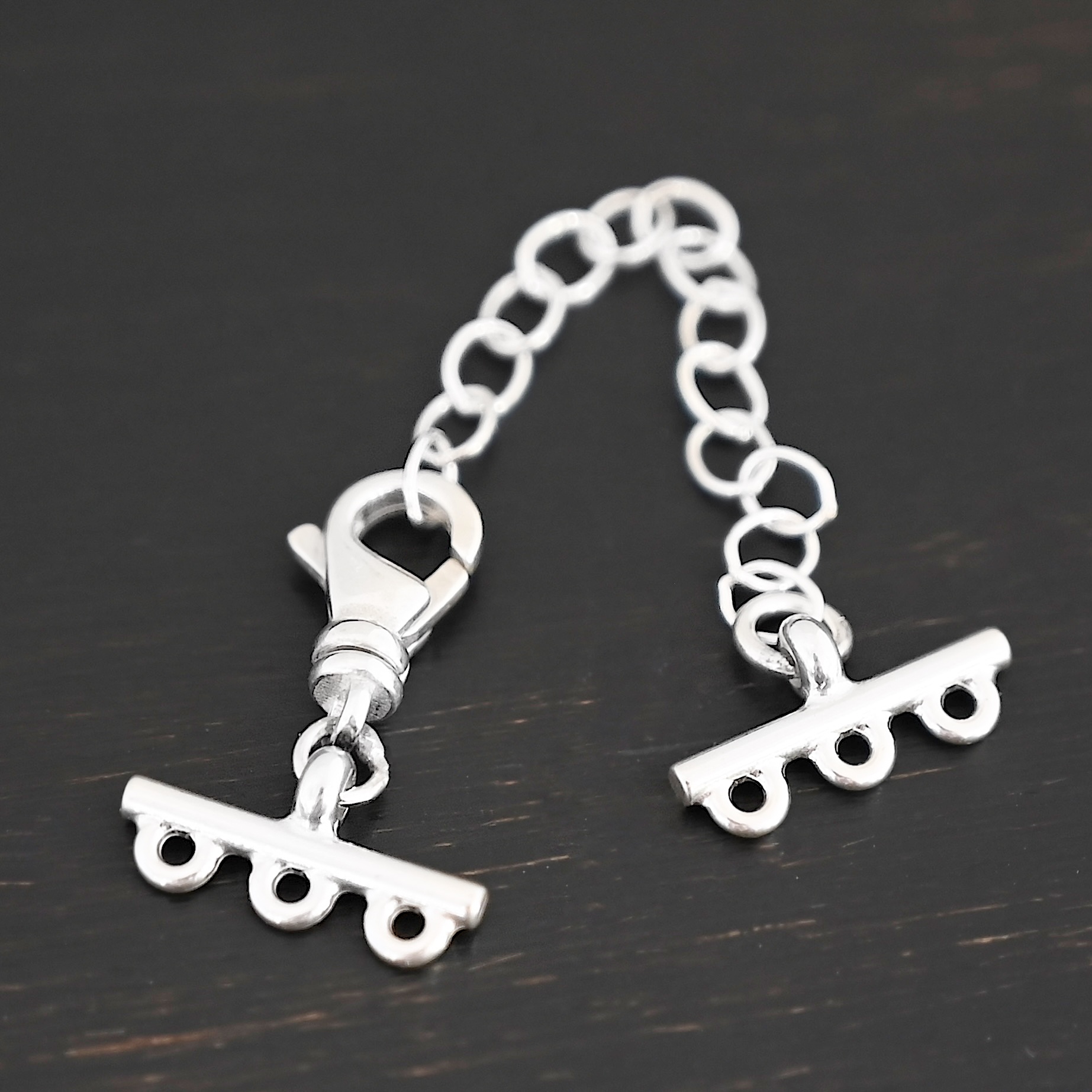 Myles multistrand clasp - shiny 3 strand Myles multistrand clasp - shiny 3 strand shown on dark background