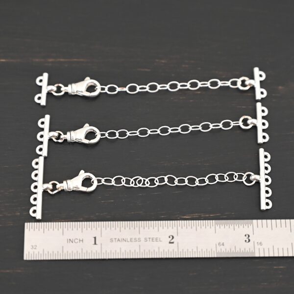 Myles multistrand clasp - shiny shown by ruler