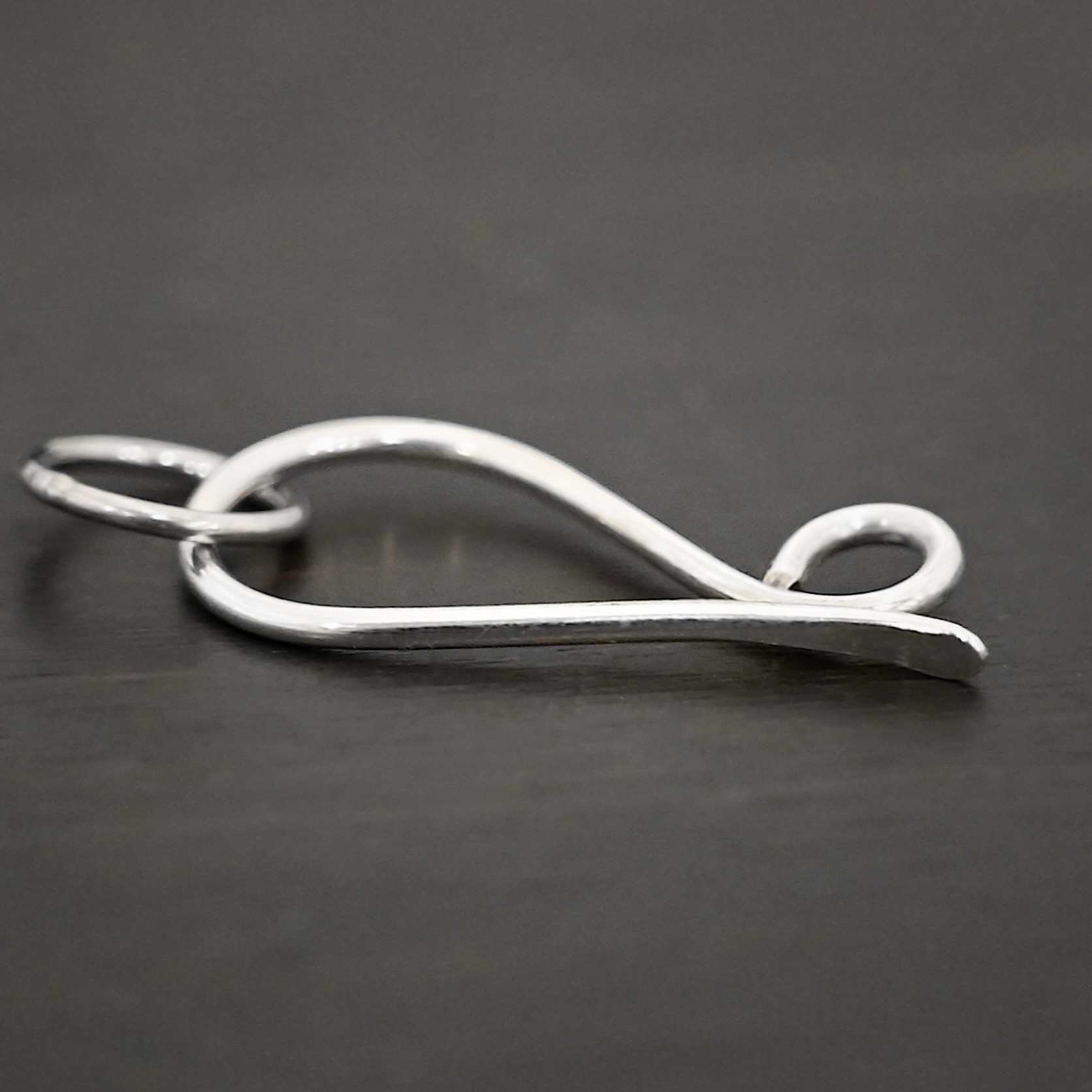 Hillary Hook Clasp - shiny Hillary Hook Clasp - shiny shown on dark background