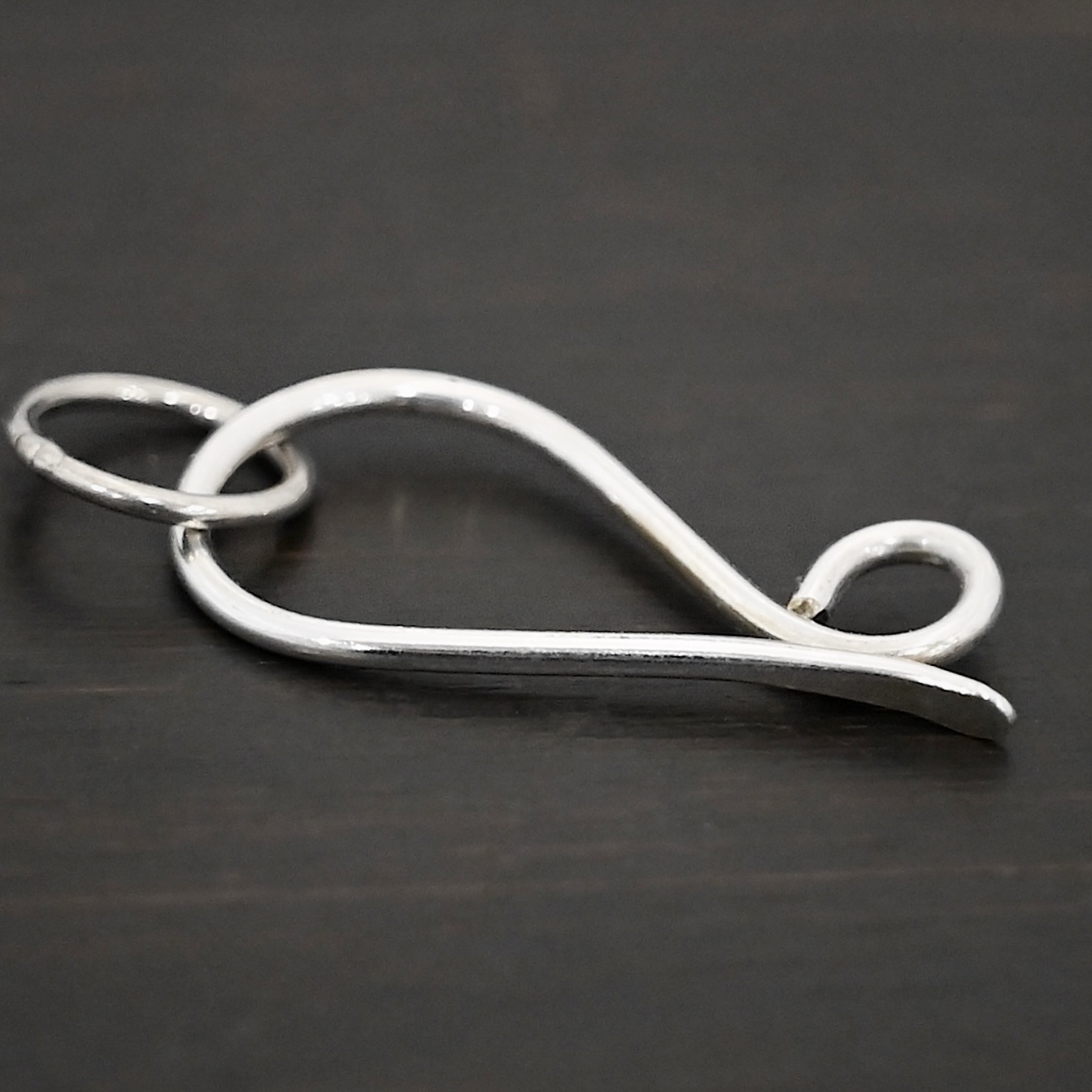 Hillary Hook Clasp - shiny Hillary Hook Clasp - shiny shown on dark background