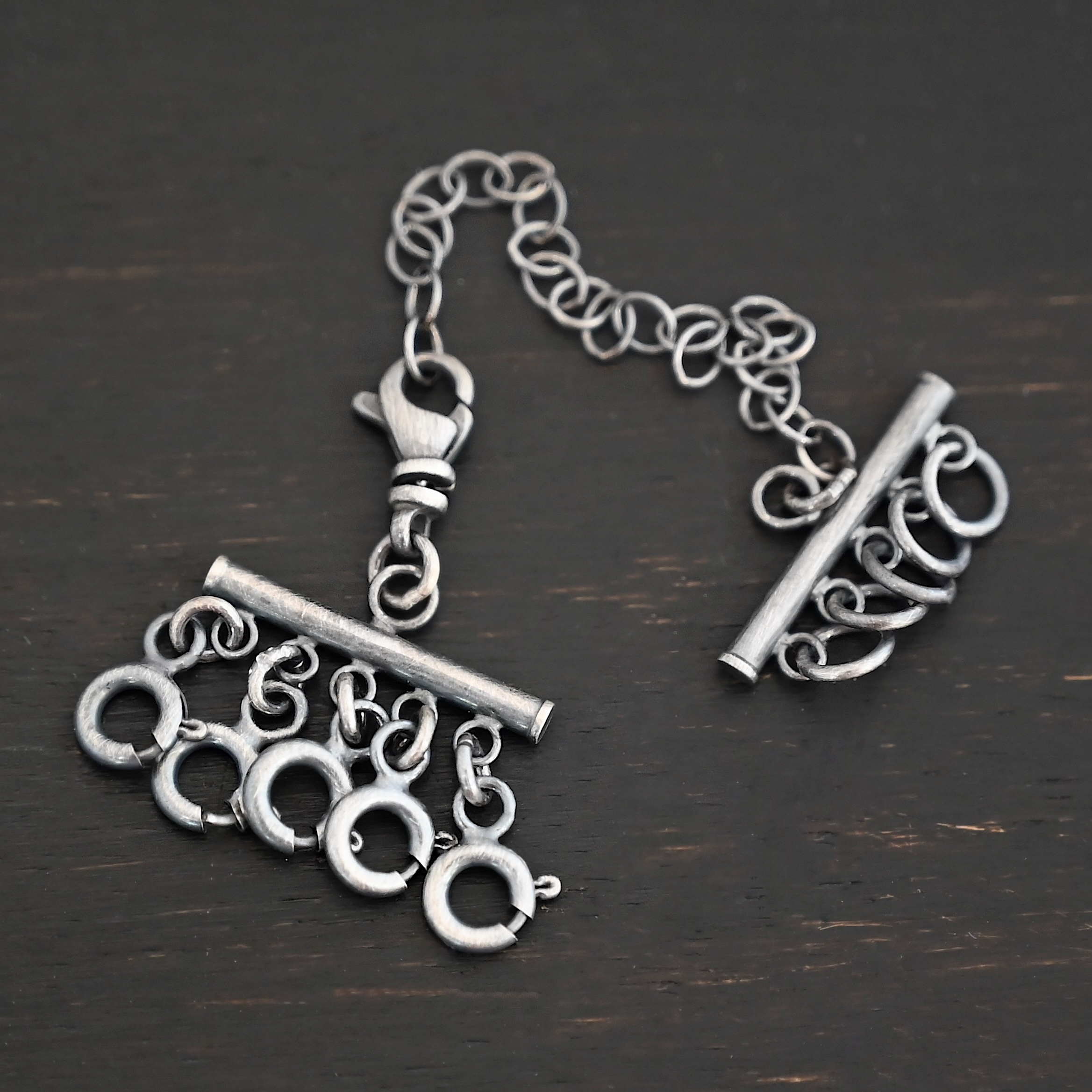 Matthew Multi strand necklace extender - oxidized 5 strand shown on dark background