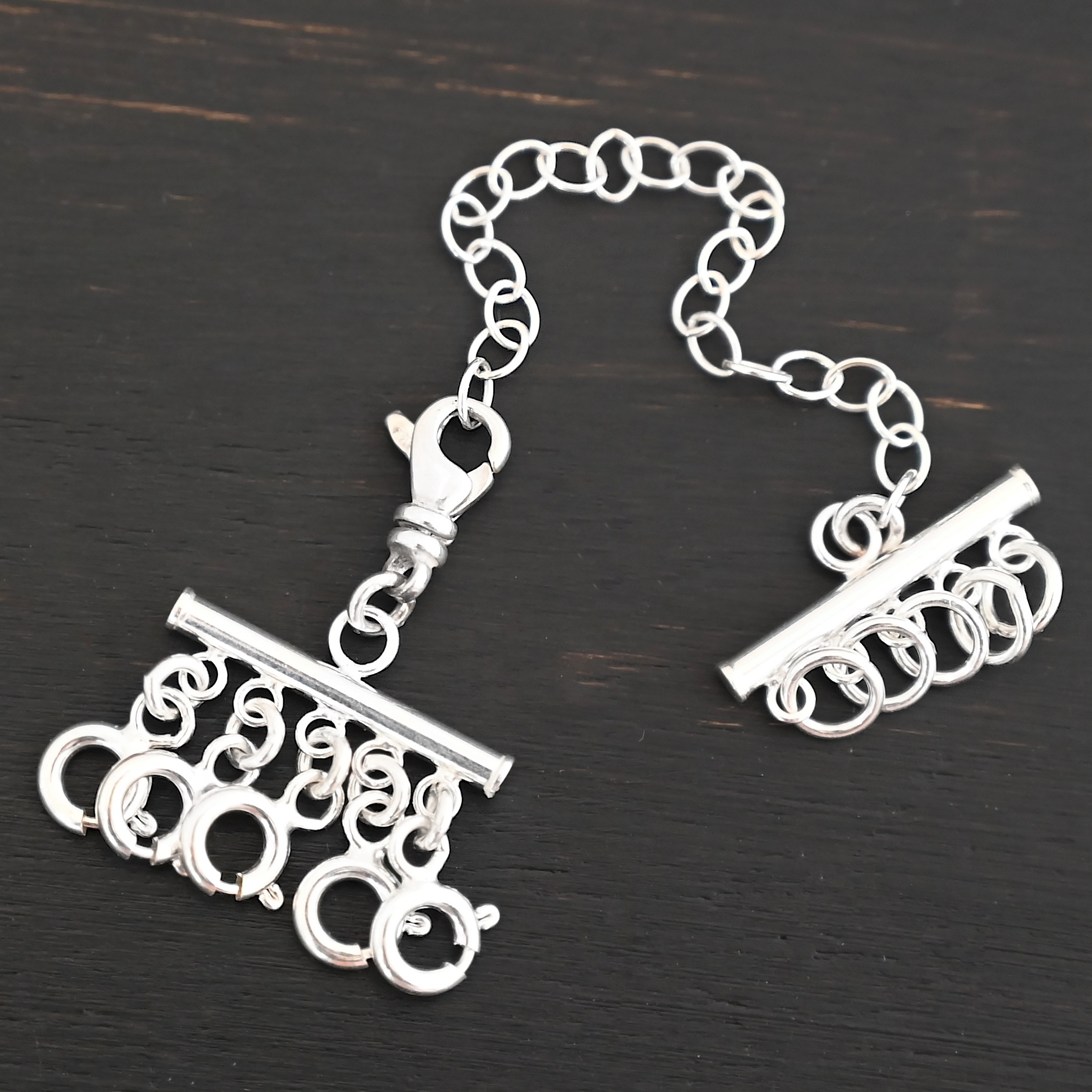 Matthew Multi strand necklace extender - shiny 5 strand shown on dark background