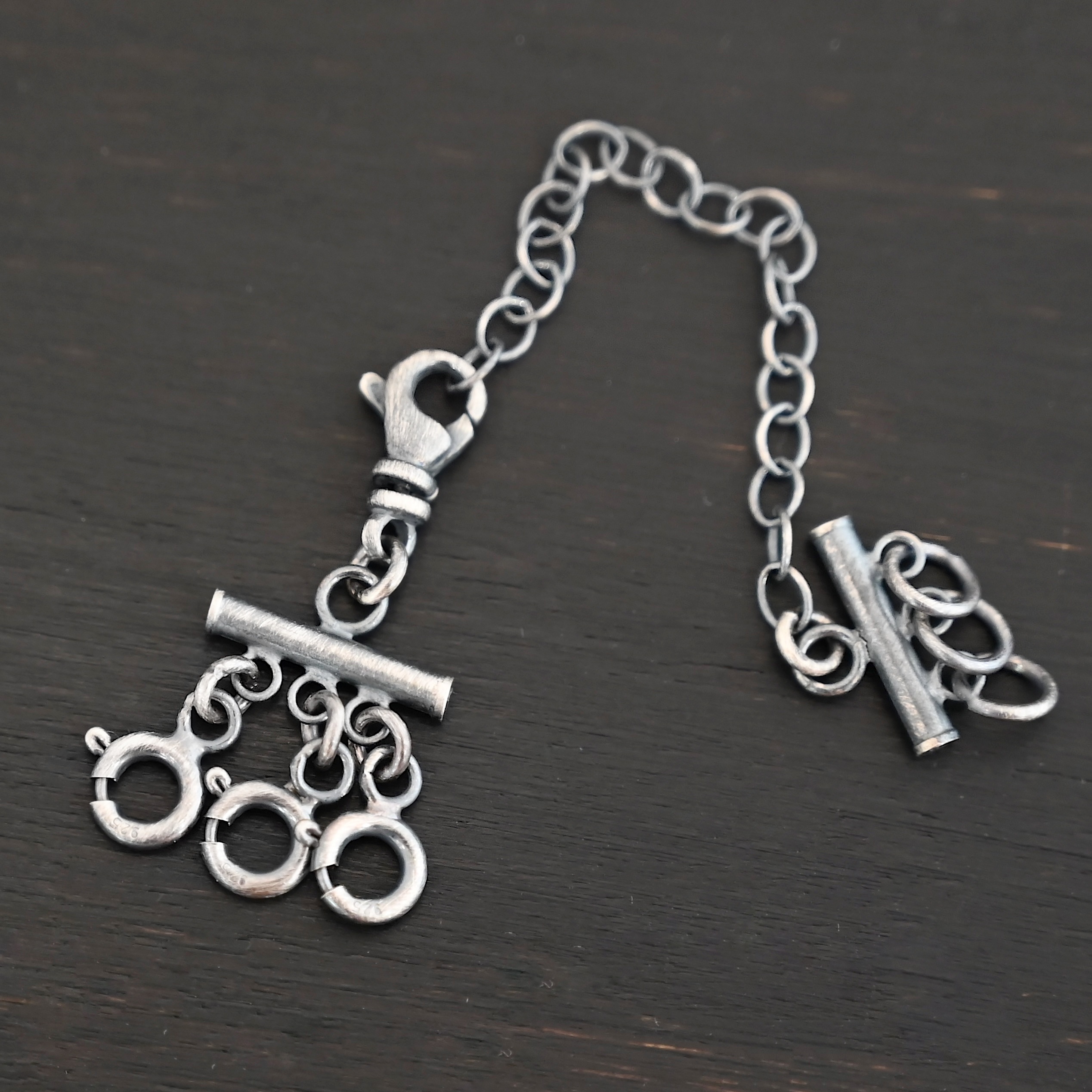 Matthew Multi strand necklace extender - oxidized 3 strand shown on dark background