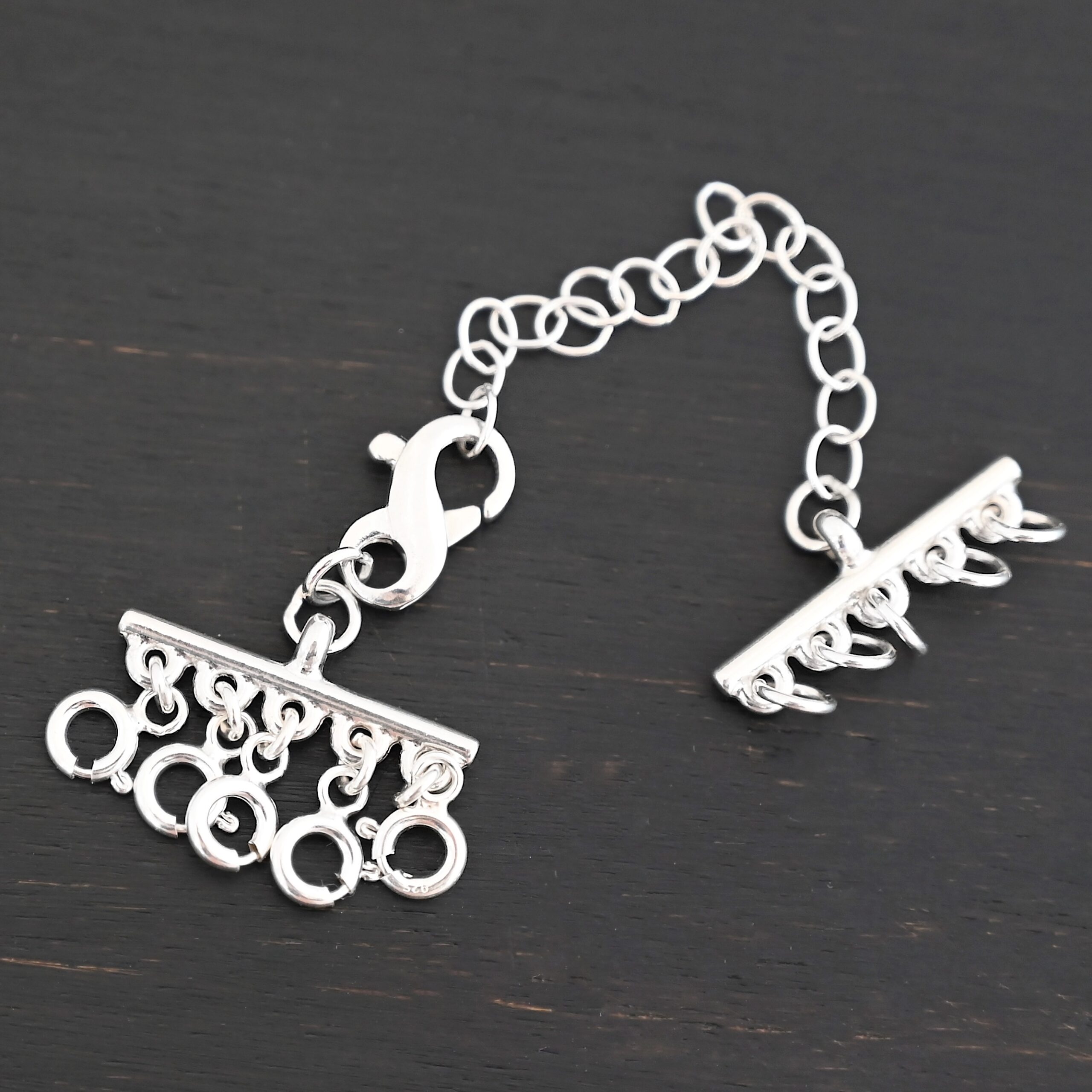 Max Multi strand necklace extender - shiny 5 strand shown on dark background