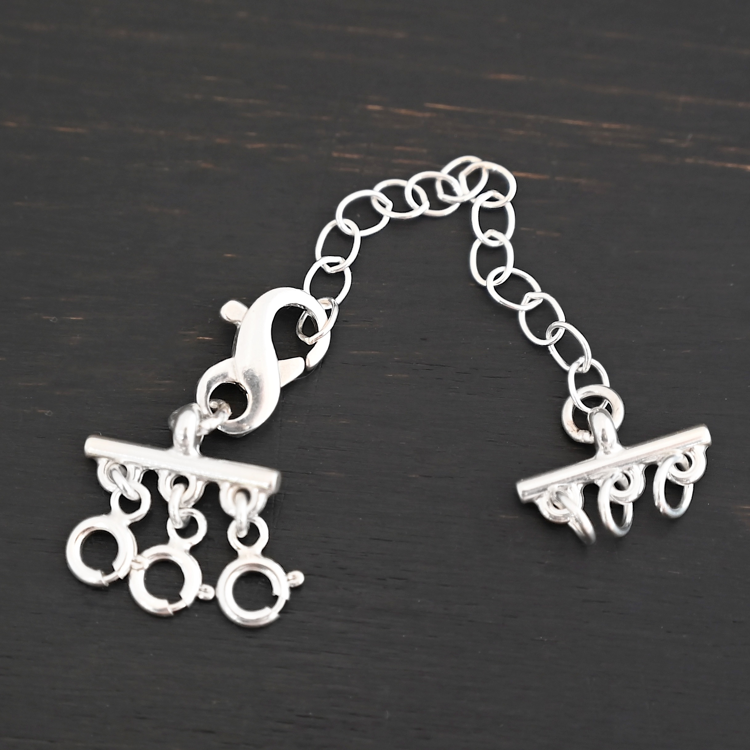 Max Multi strand necklace extender - shiny 3 strand shown on dark background