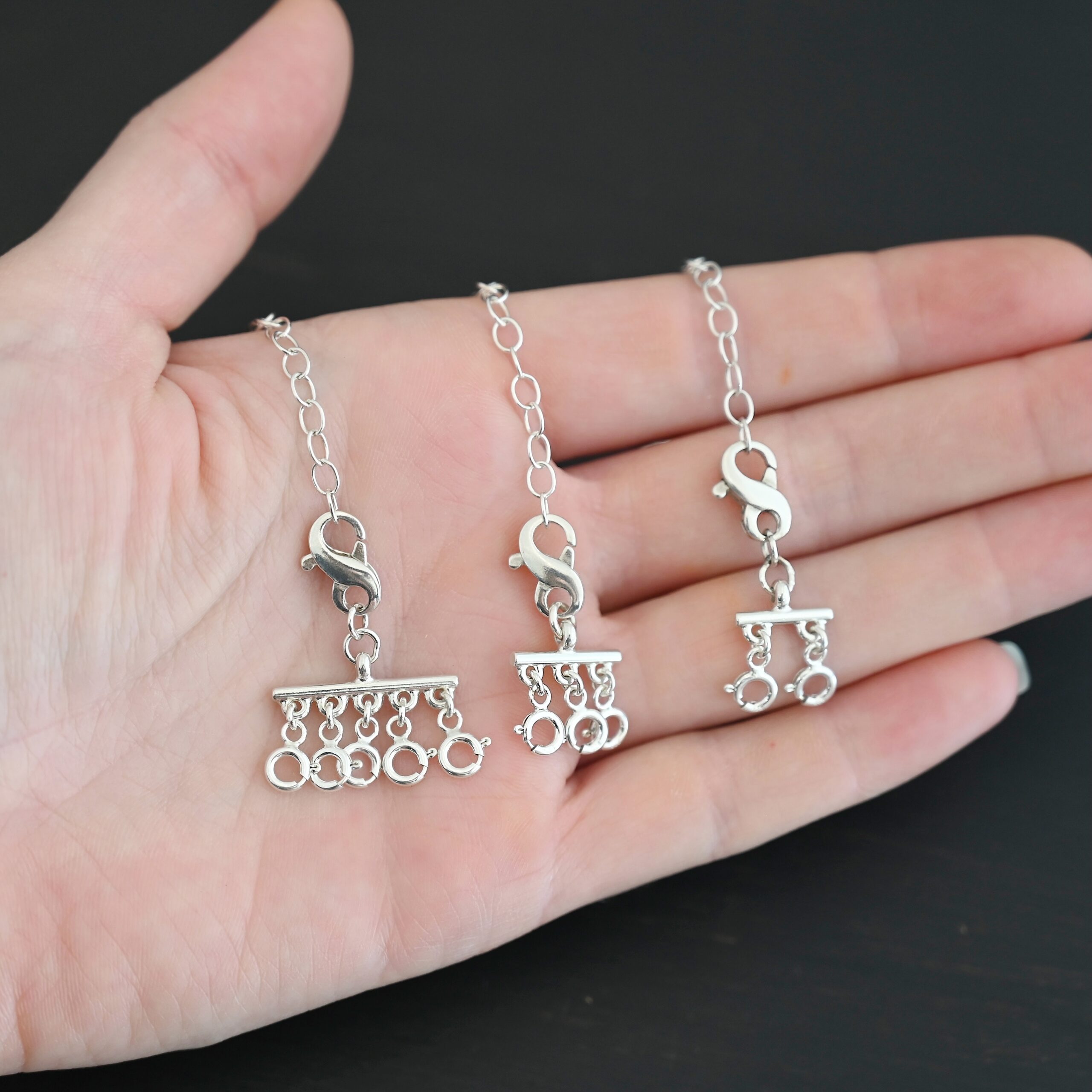 Max Multi strand necklace extender - shiny shown in hand