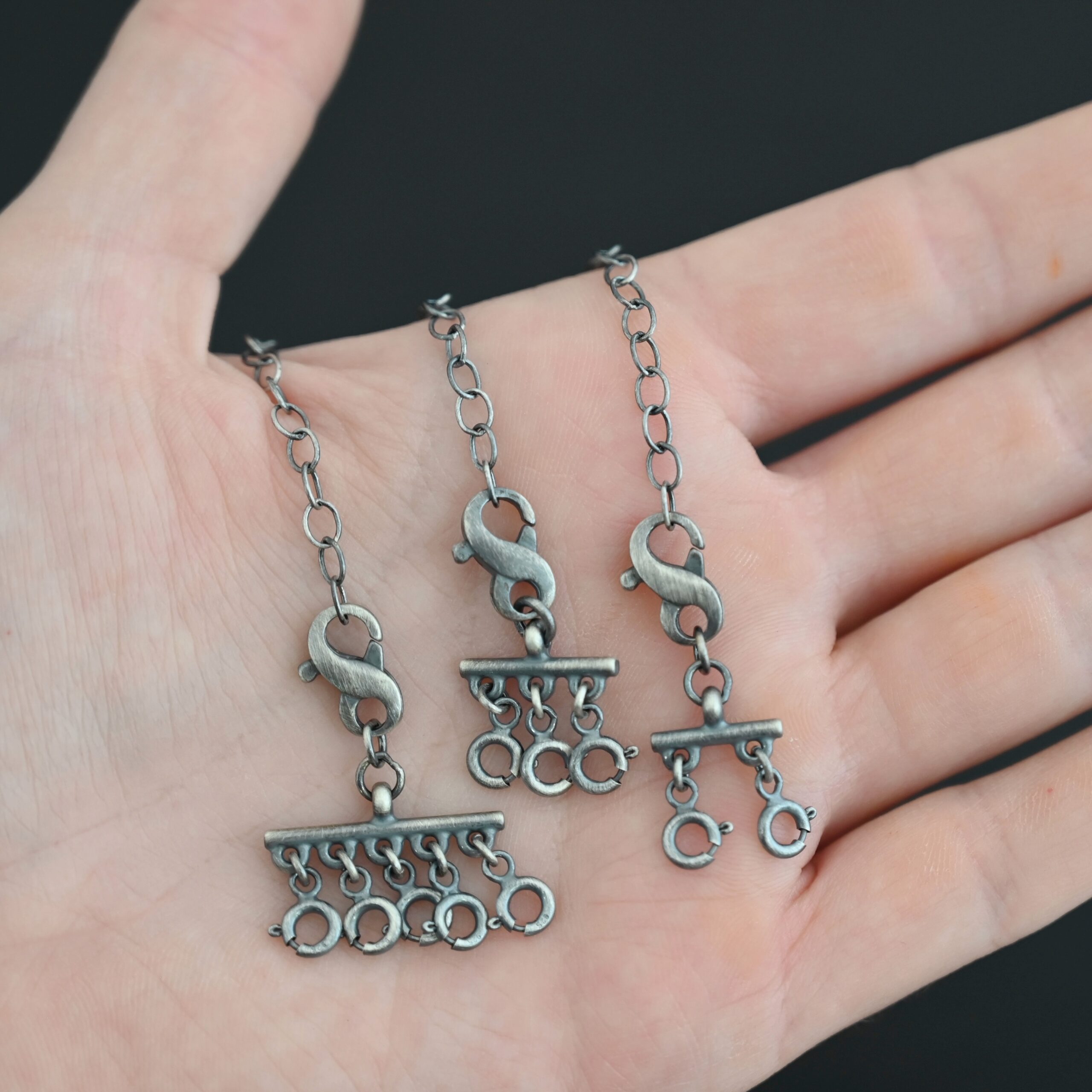 Max Multi strand necklace extender - oxidized shown in hand