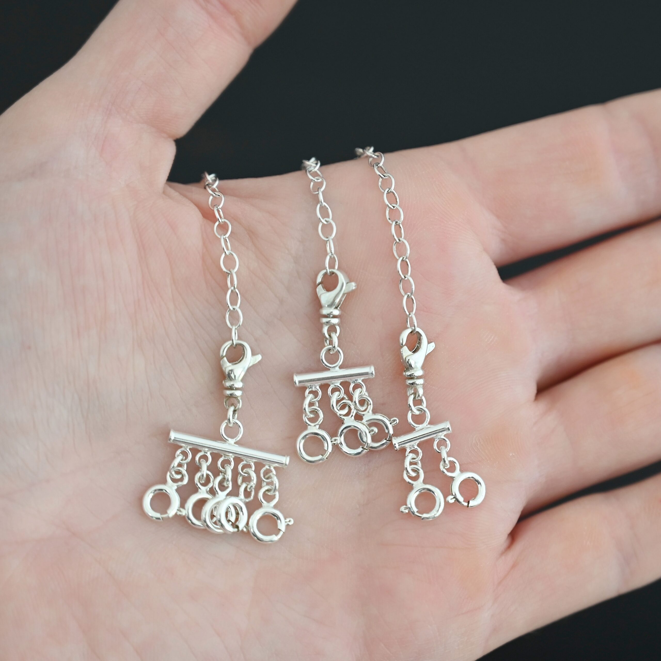 Matthew Multi strand necklace extender - shiny shown in hand