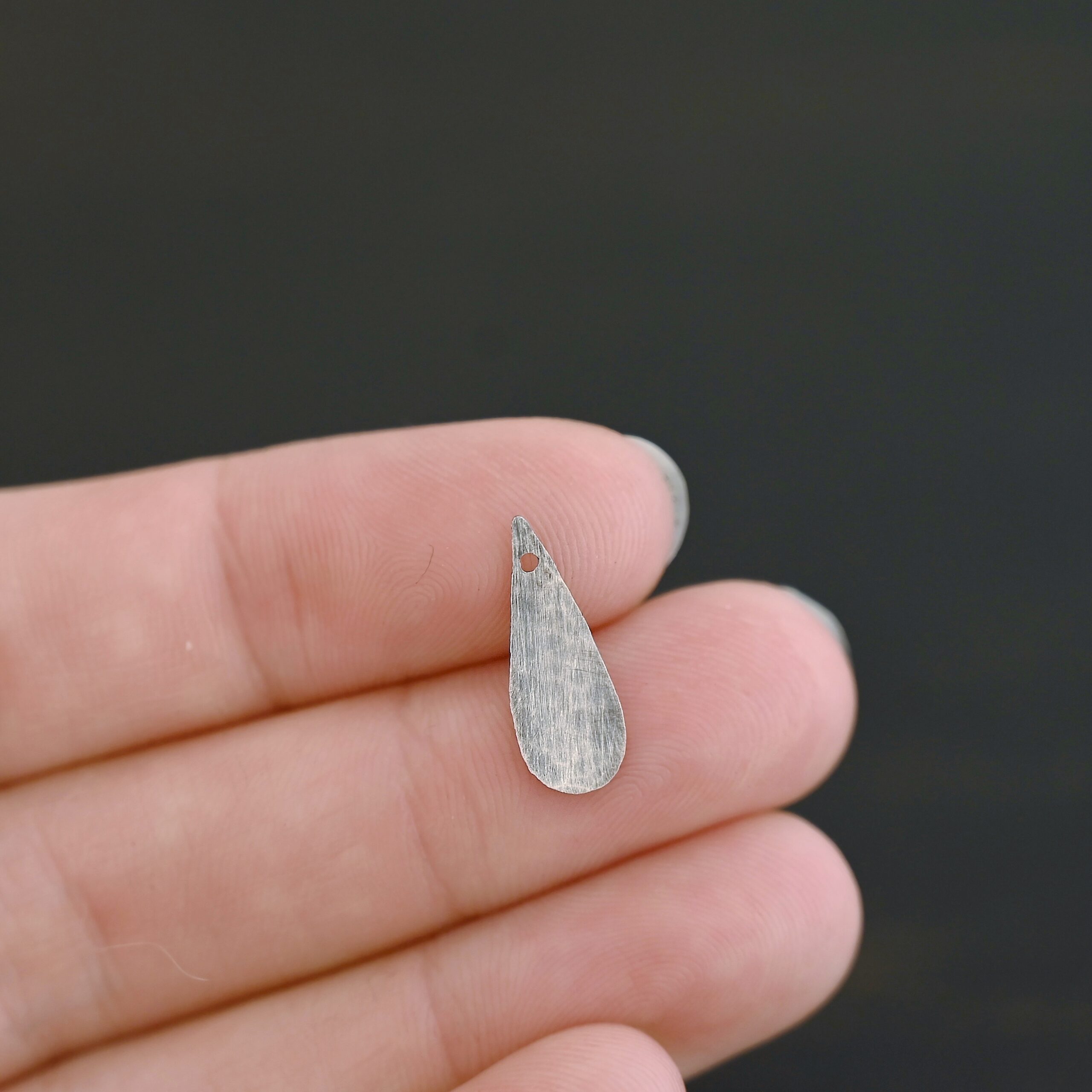 Sterling Silver Teardrop Blank - oxidized hammered shown by hand