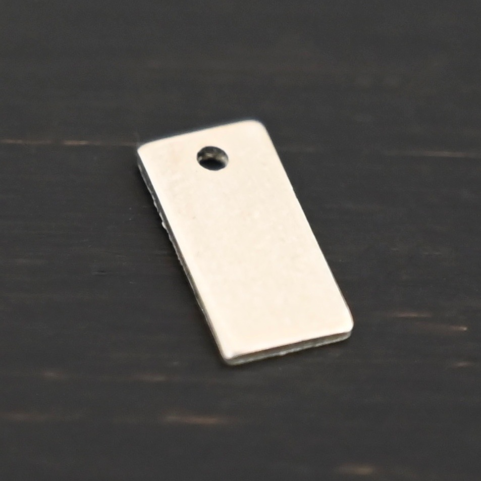 Sterling Silver small rectangle blank - shiny smooth 1 hole shown on dark background