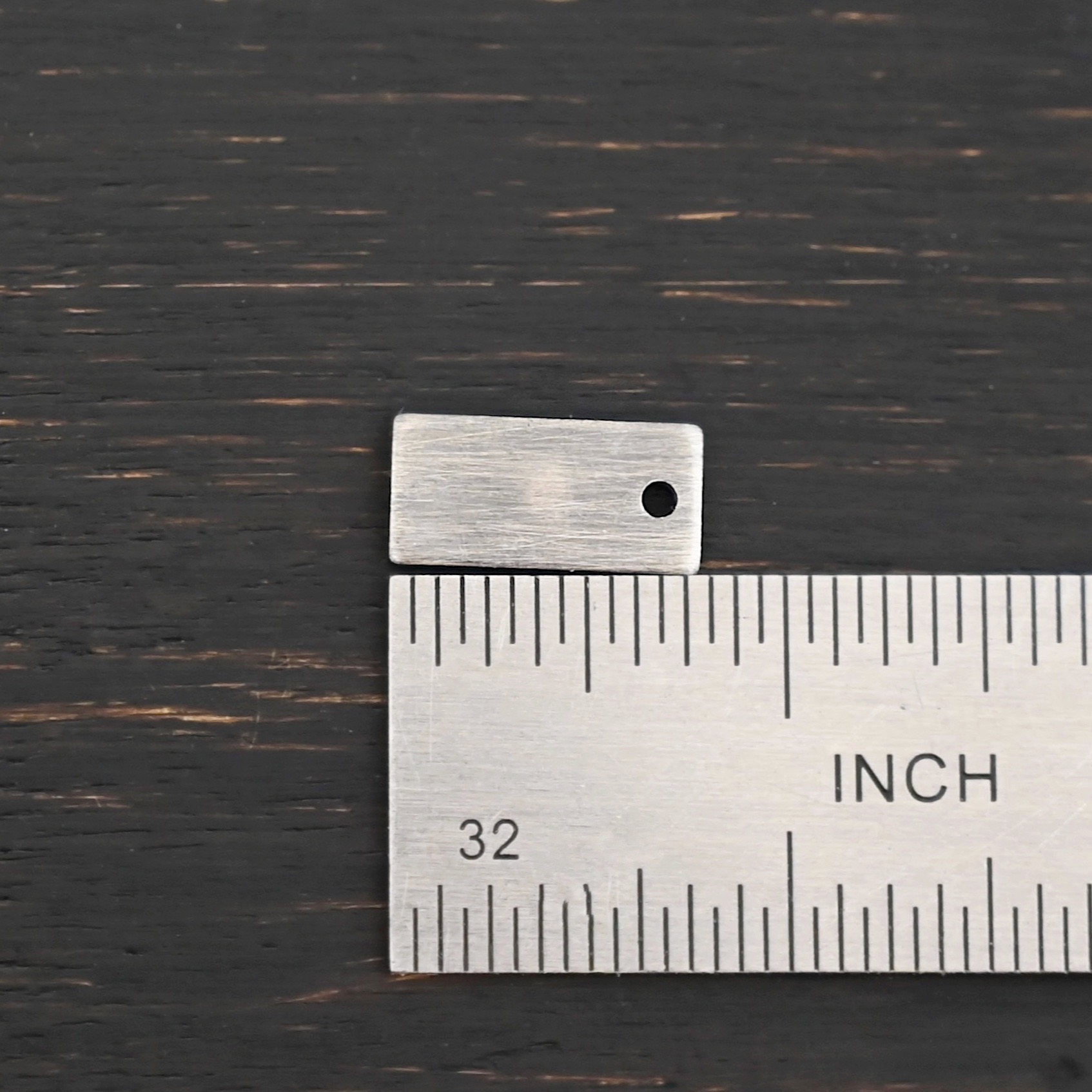 Sterling Silver small rectangle blank - oxidized smooth 1 hole shown by ruler