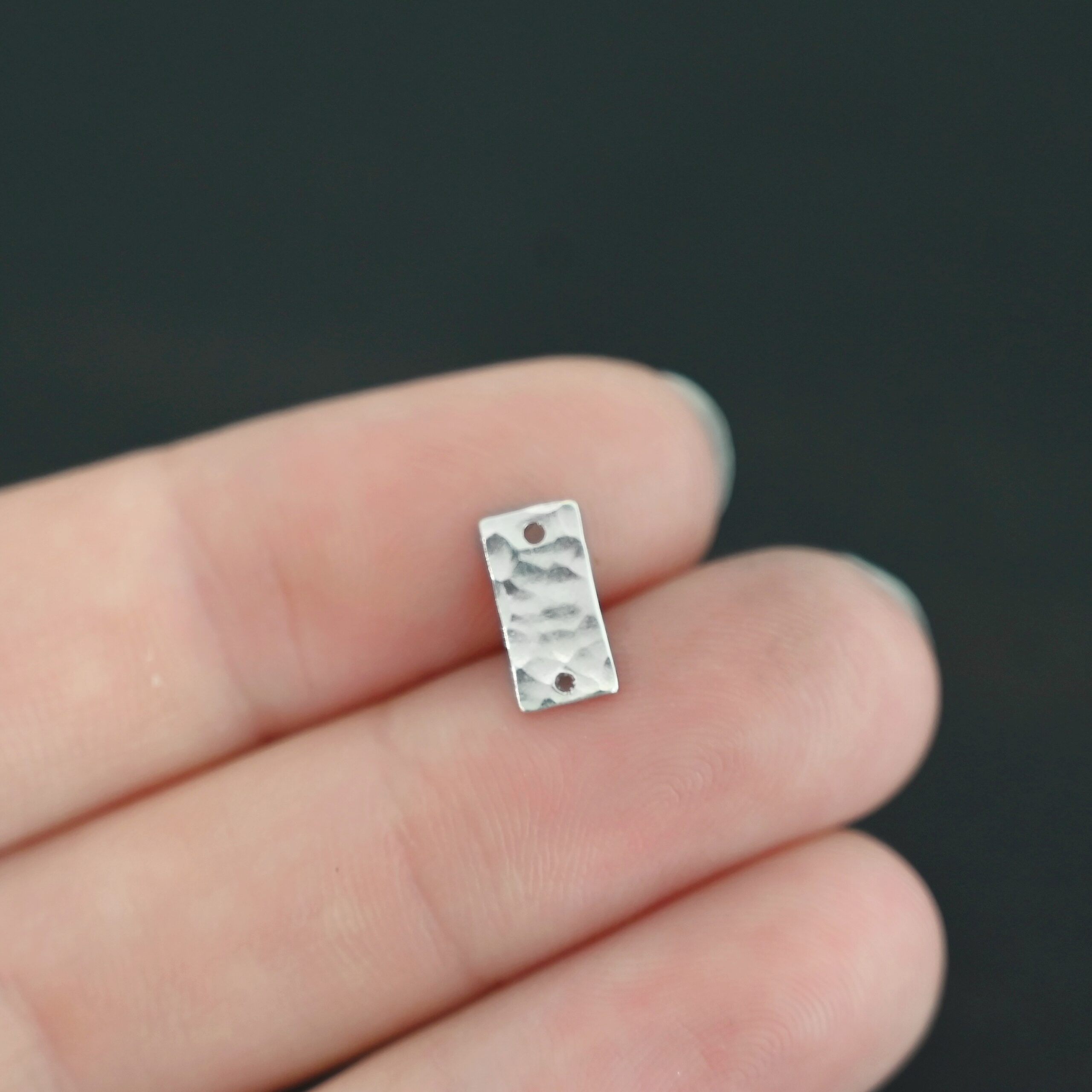 Sterling Silver small rectangle blank - shiny hammered 2 holes shown in hand