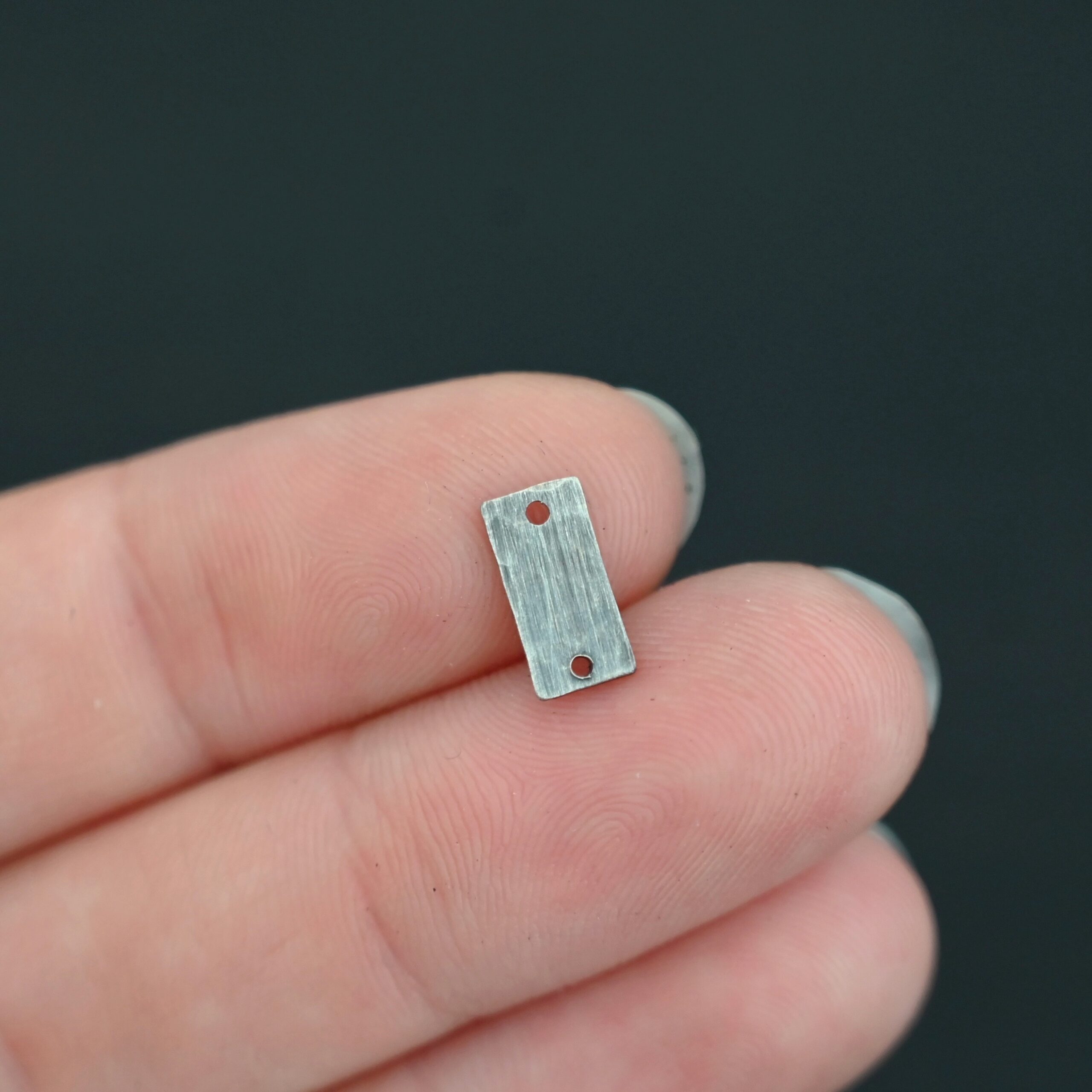 Sterling Silver small rectangle blank - oxidized hammered 2 holes shown in hand