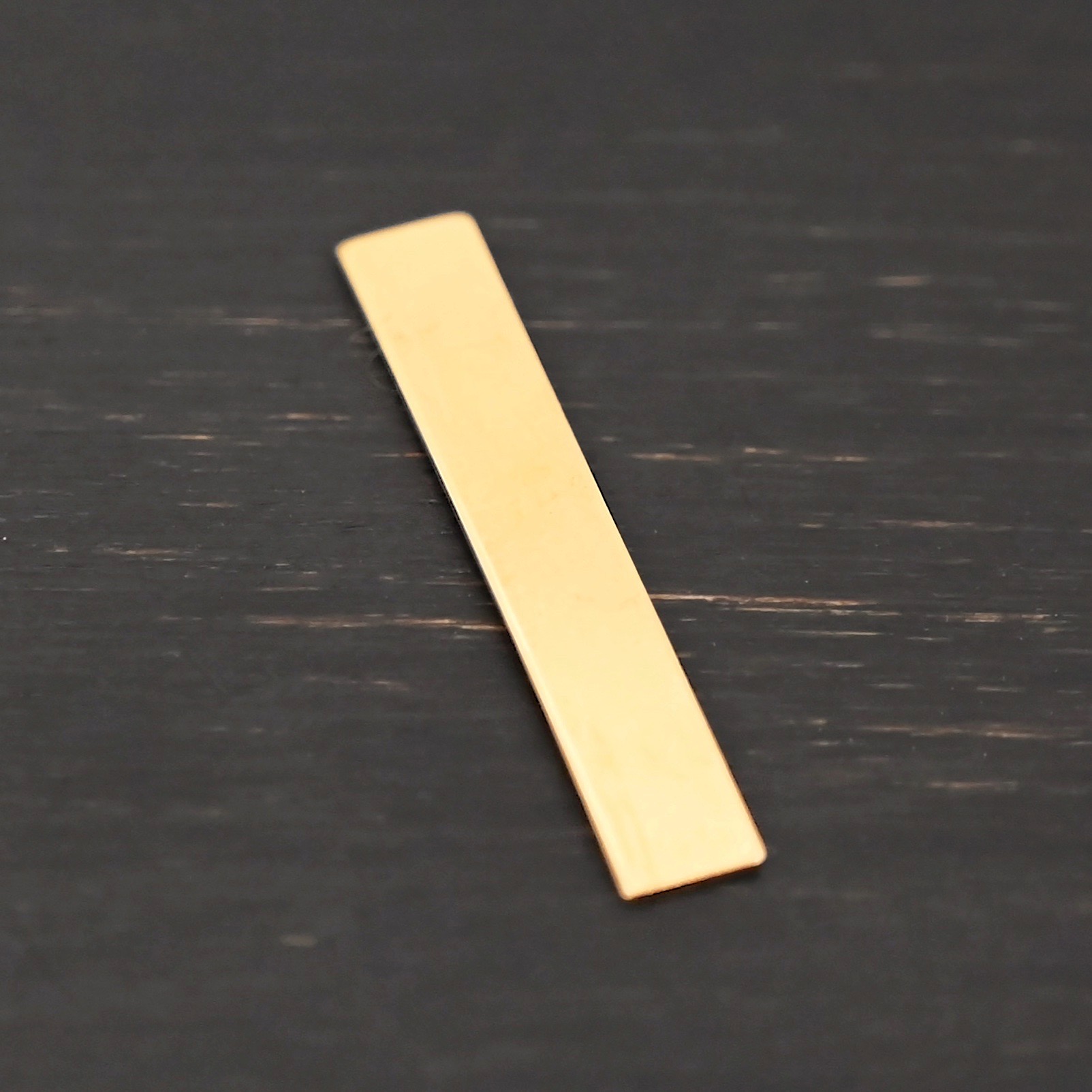 14k gold filled large rectangle blank - smooth 0 holes shown on dark background