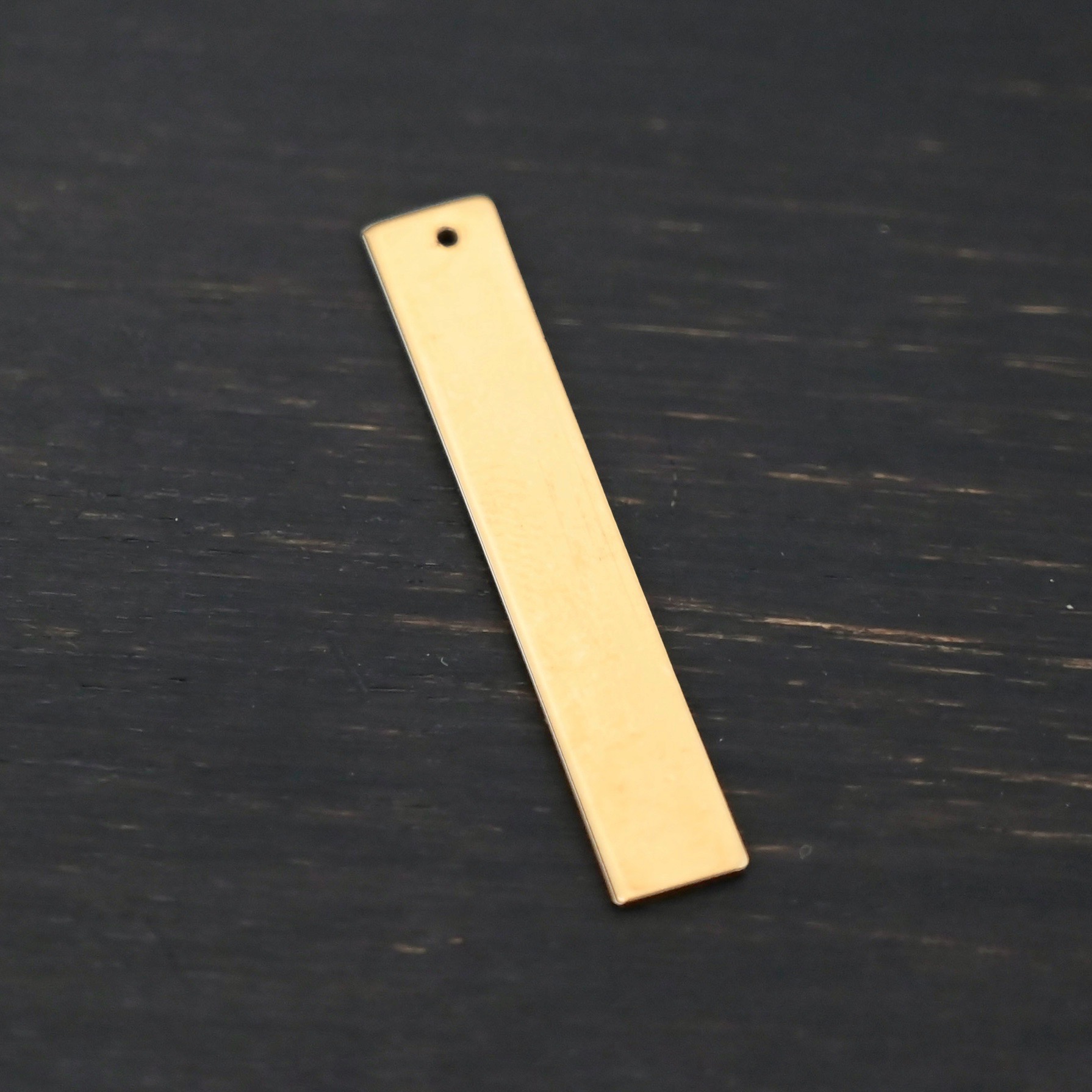 14k gold filled large rectangle blank - smooth 1 hole shown on dark background