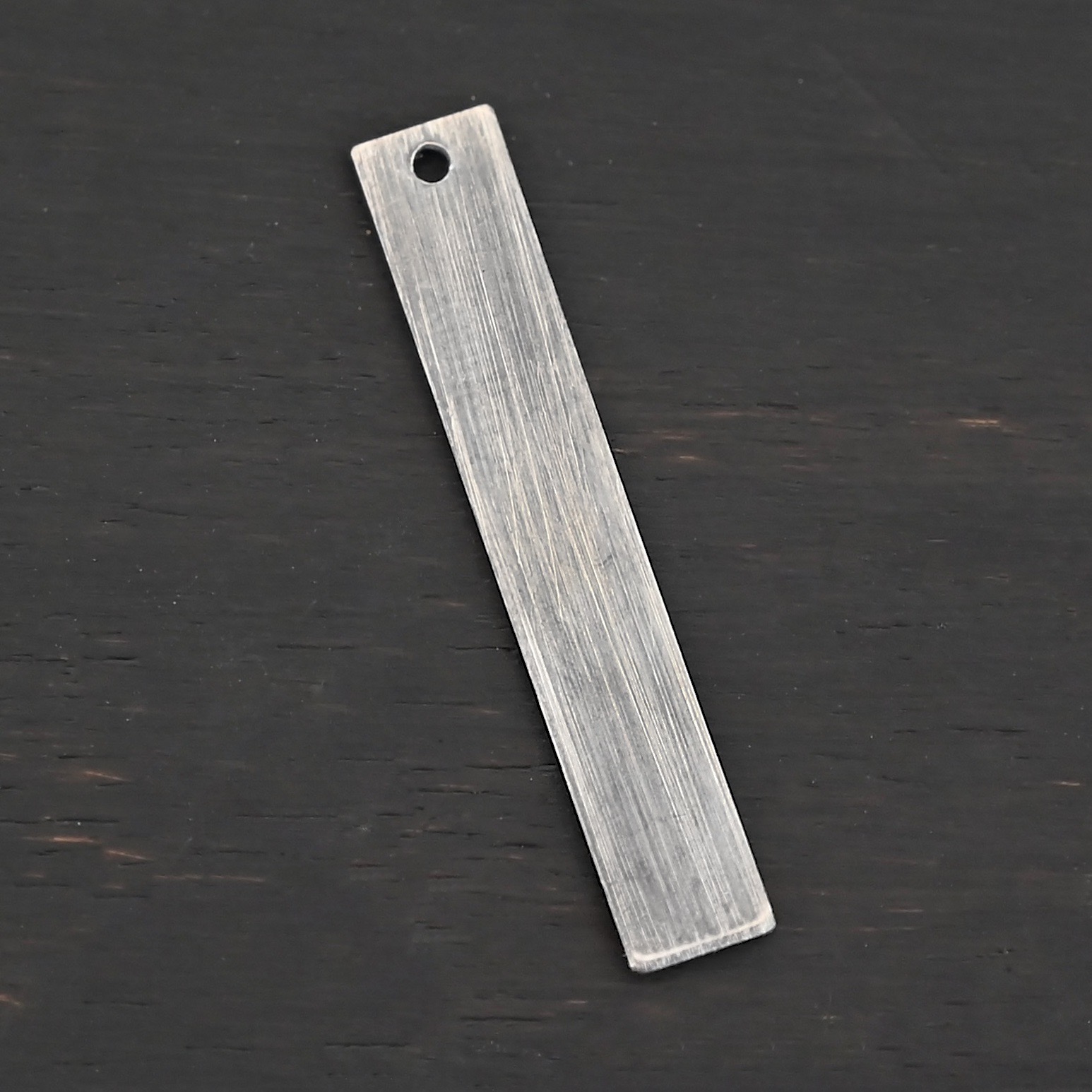 Sterling Silver Large Rectangle Blank - oxidized smooth 1 hole shown on dark background