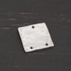 Hammered Square - shiny 3 holes shown in dark background
