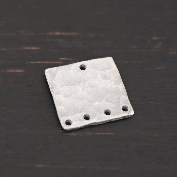 Hammered Square - shiny 5 holes shown in dark background