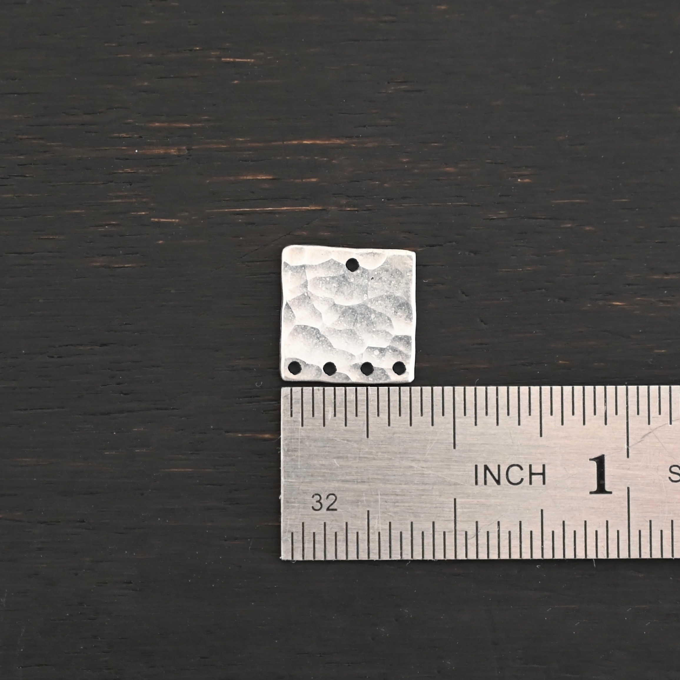 Hammered Square - shiny 5 holes Hammered Square - shiny 5 holes shown by ruler