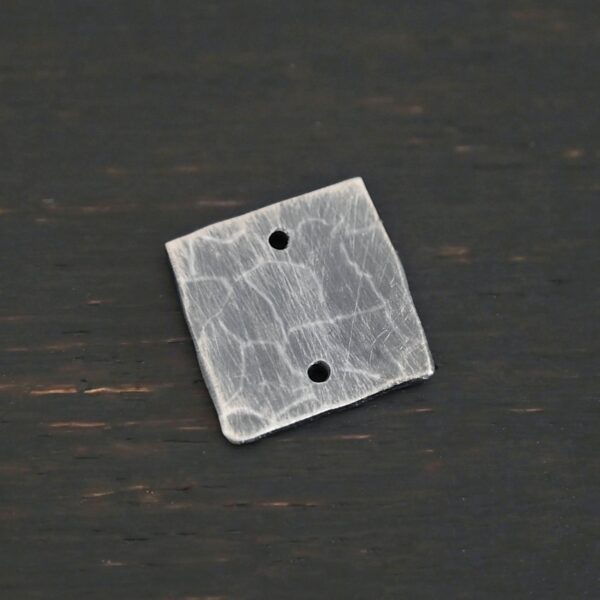 Hammered Square - oxidized 2 holes shown on dark background