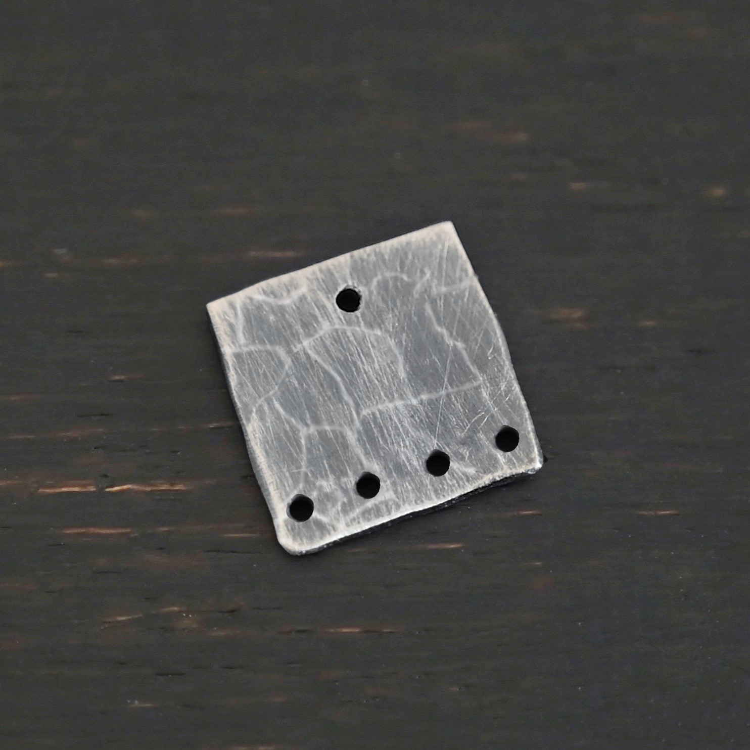 Hammered Square - oxidized 5 holes Hammered Square - oxidized 5 holes shown on dark background