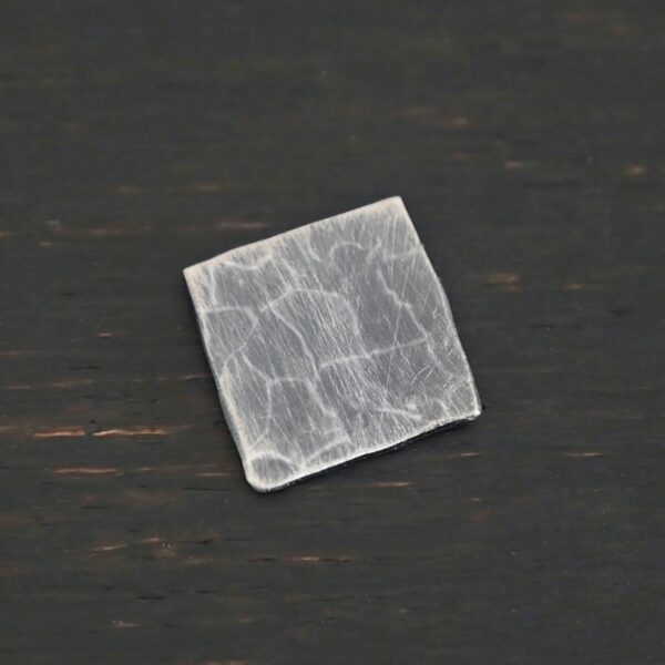 Hammered Square - oxidized 0 holes shown on dark background