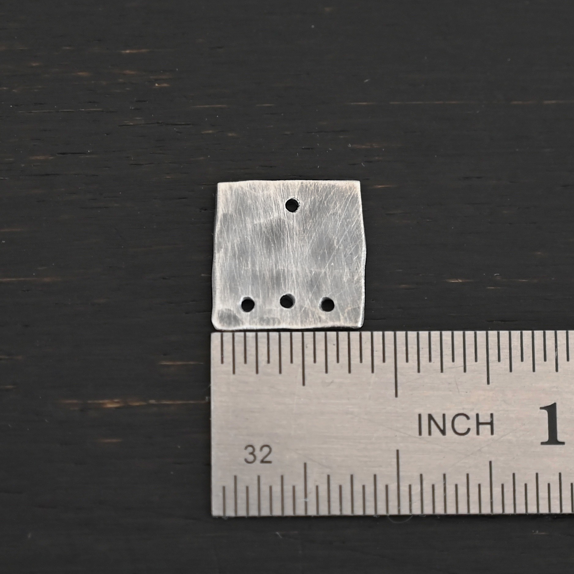 Hammered Square - oxidized 4 holes Hammered Square - oxidized 4 holes shown by ruler