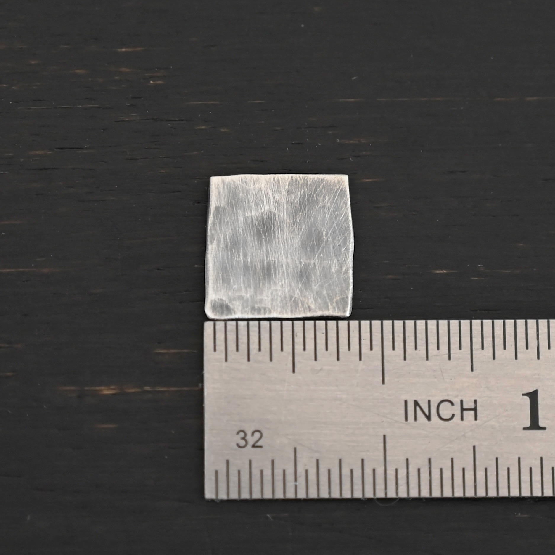 Hammered Square - oxidized 0 holes Hammered Square - oxidized 0 holes shown by ruler