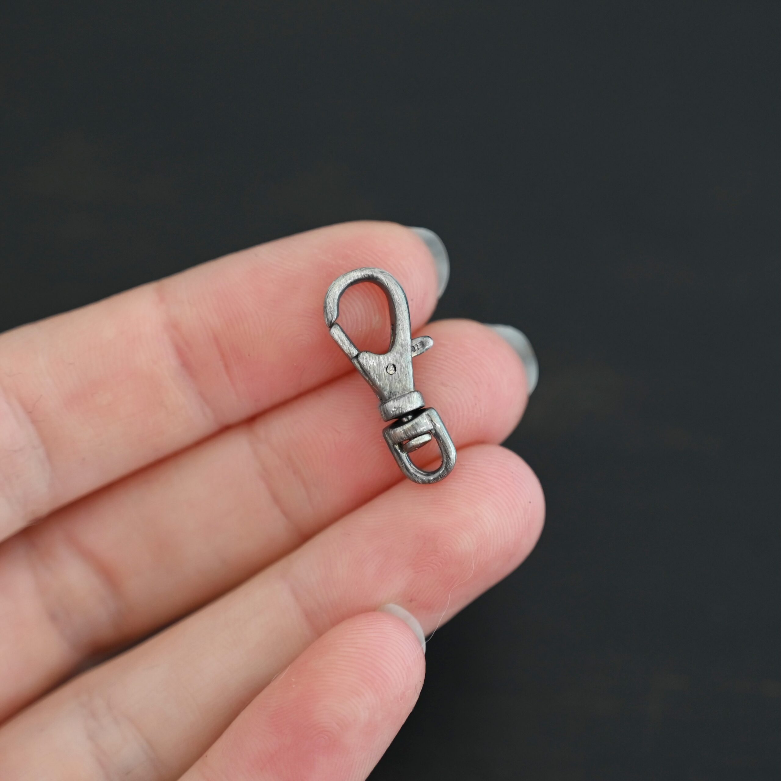 Sofia Swivel Lobster Claw - oxidized shown in hand